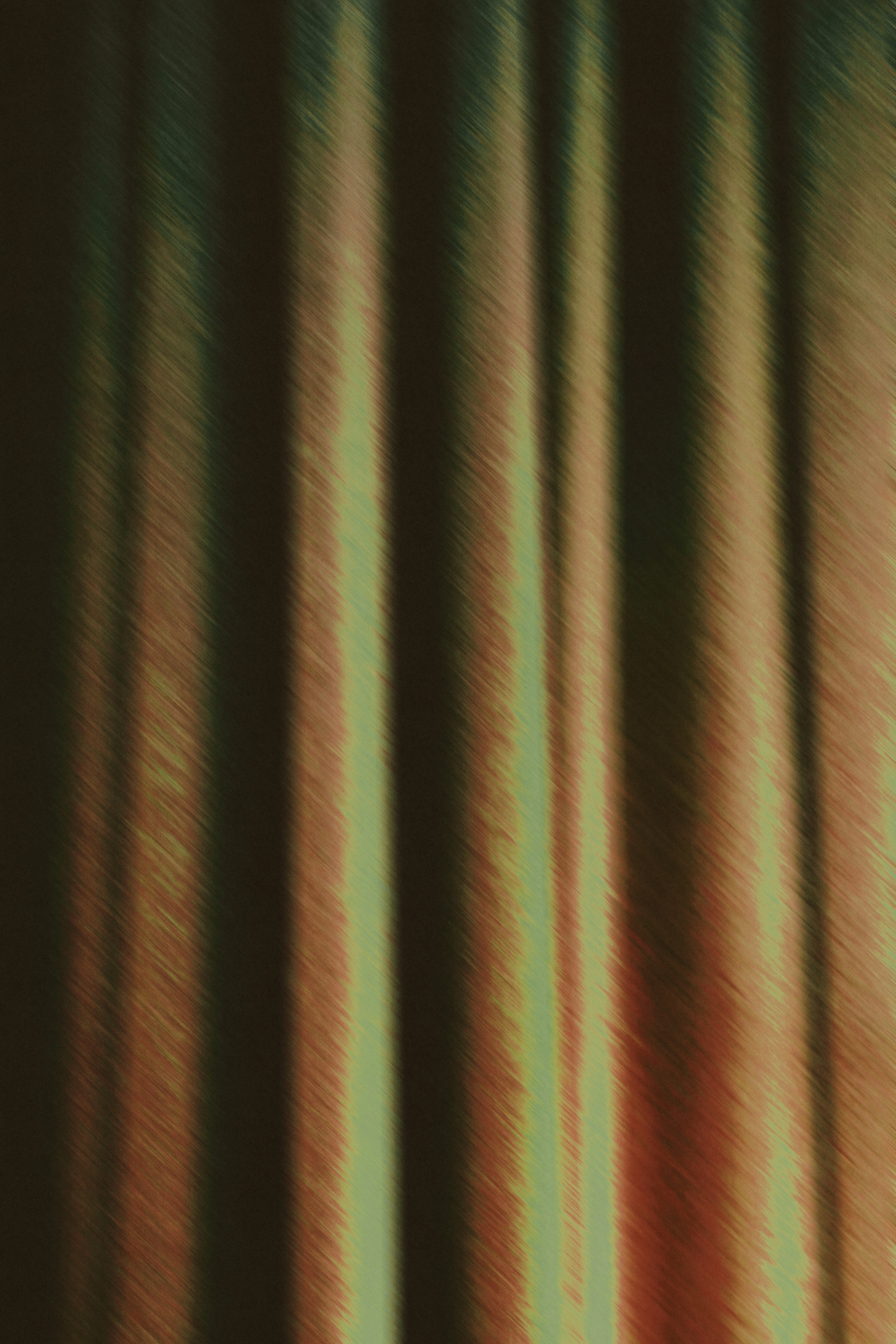 Vertical folds of dark green and brown fabric with a subtle brushed texture