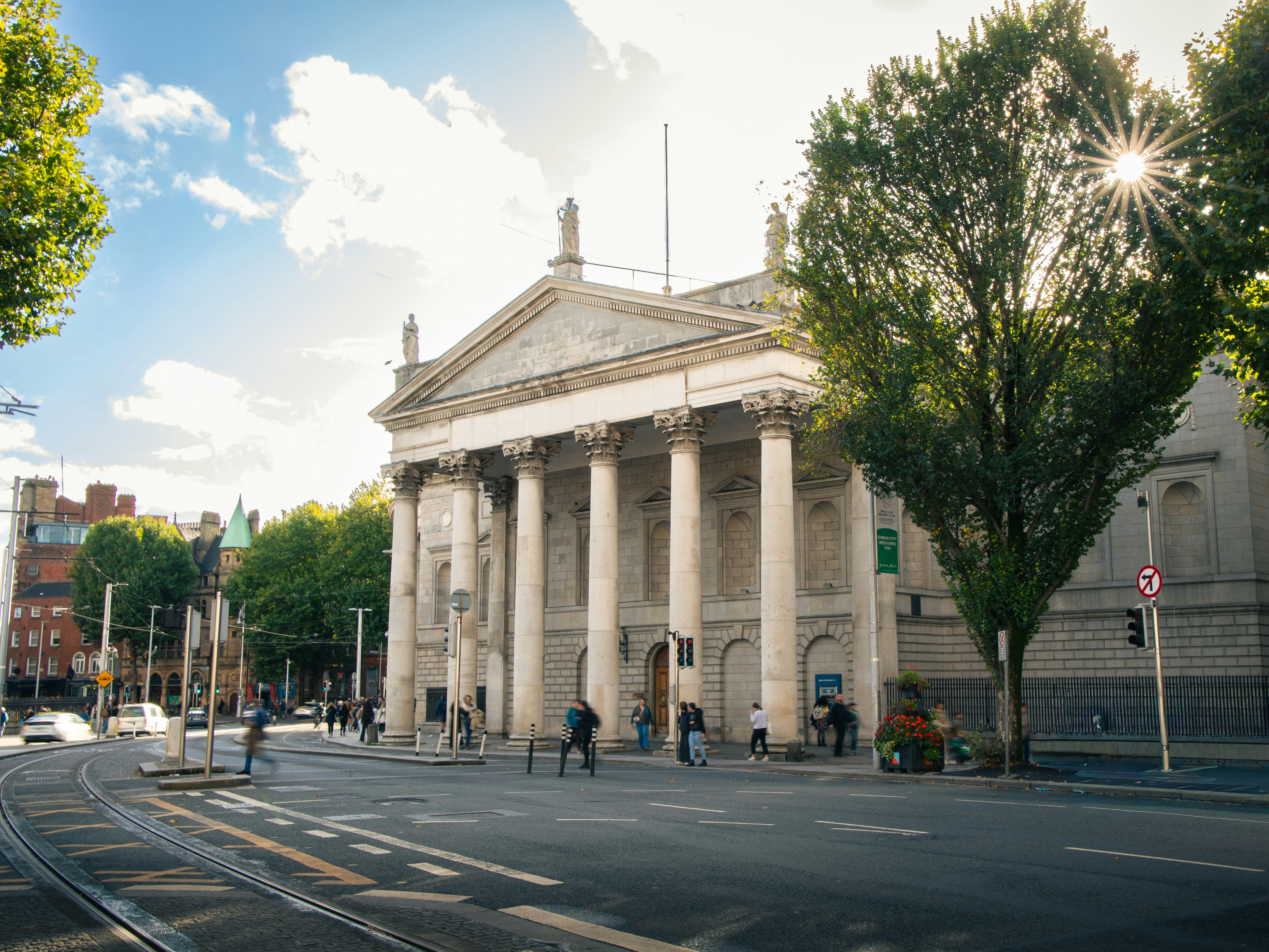 The Bank of Ireland building with neoclassical columns on a street in Dublin