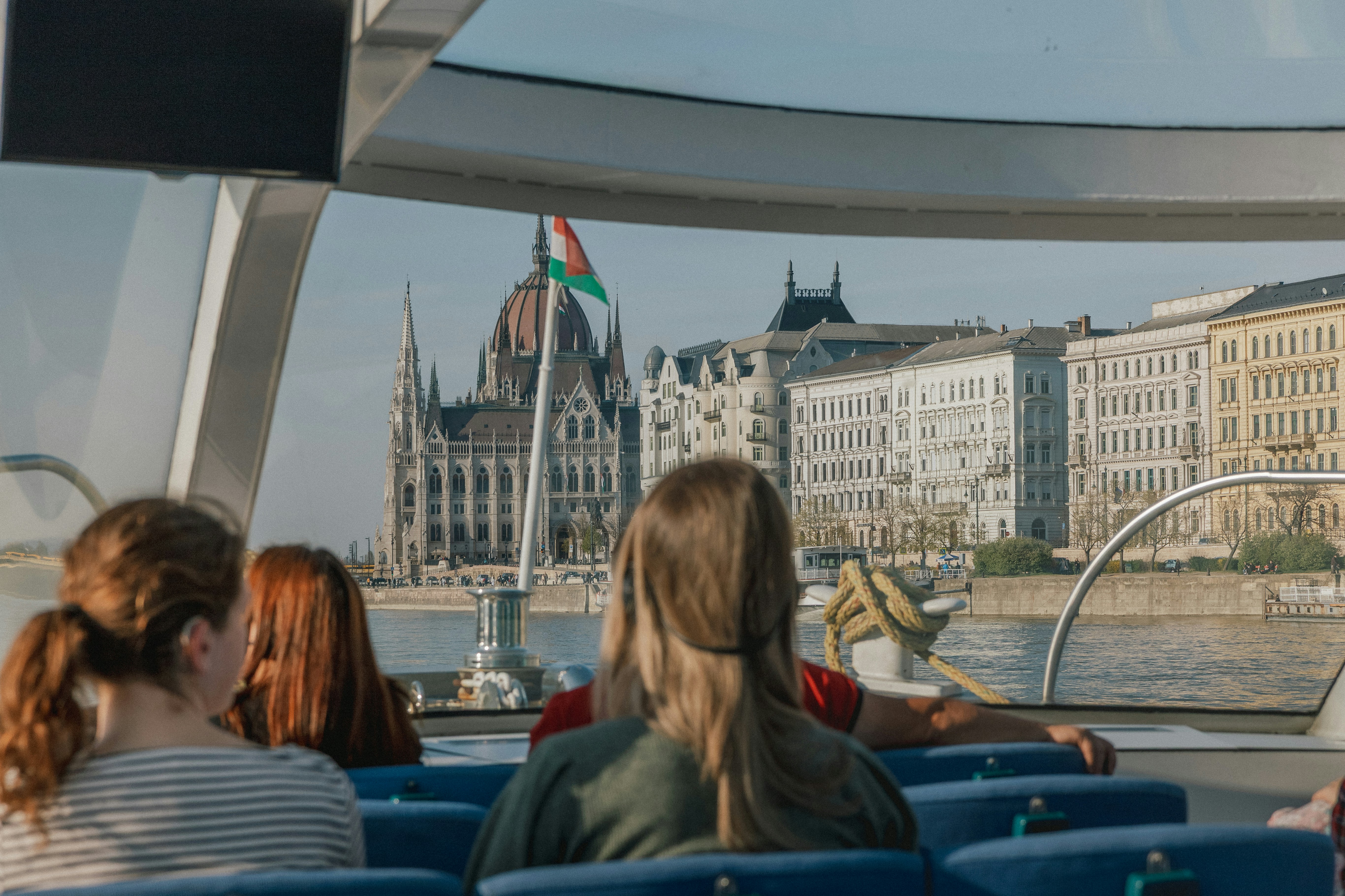 People on a boat viewing the Hungarian Parliament Building in Budapest