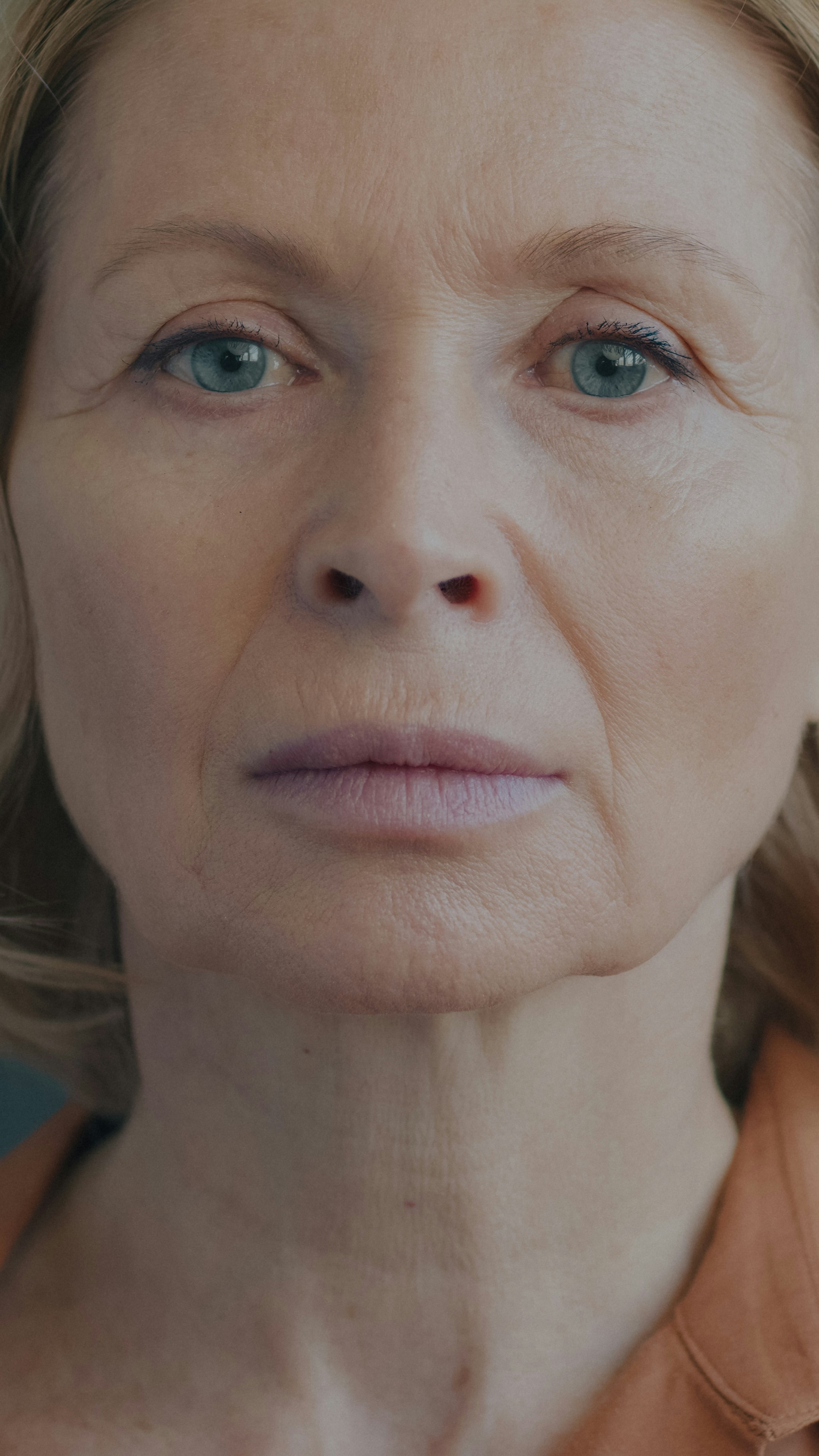 Close-up portrait of a woman with blue eyes and blonde hair