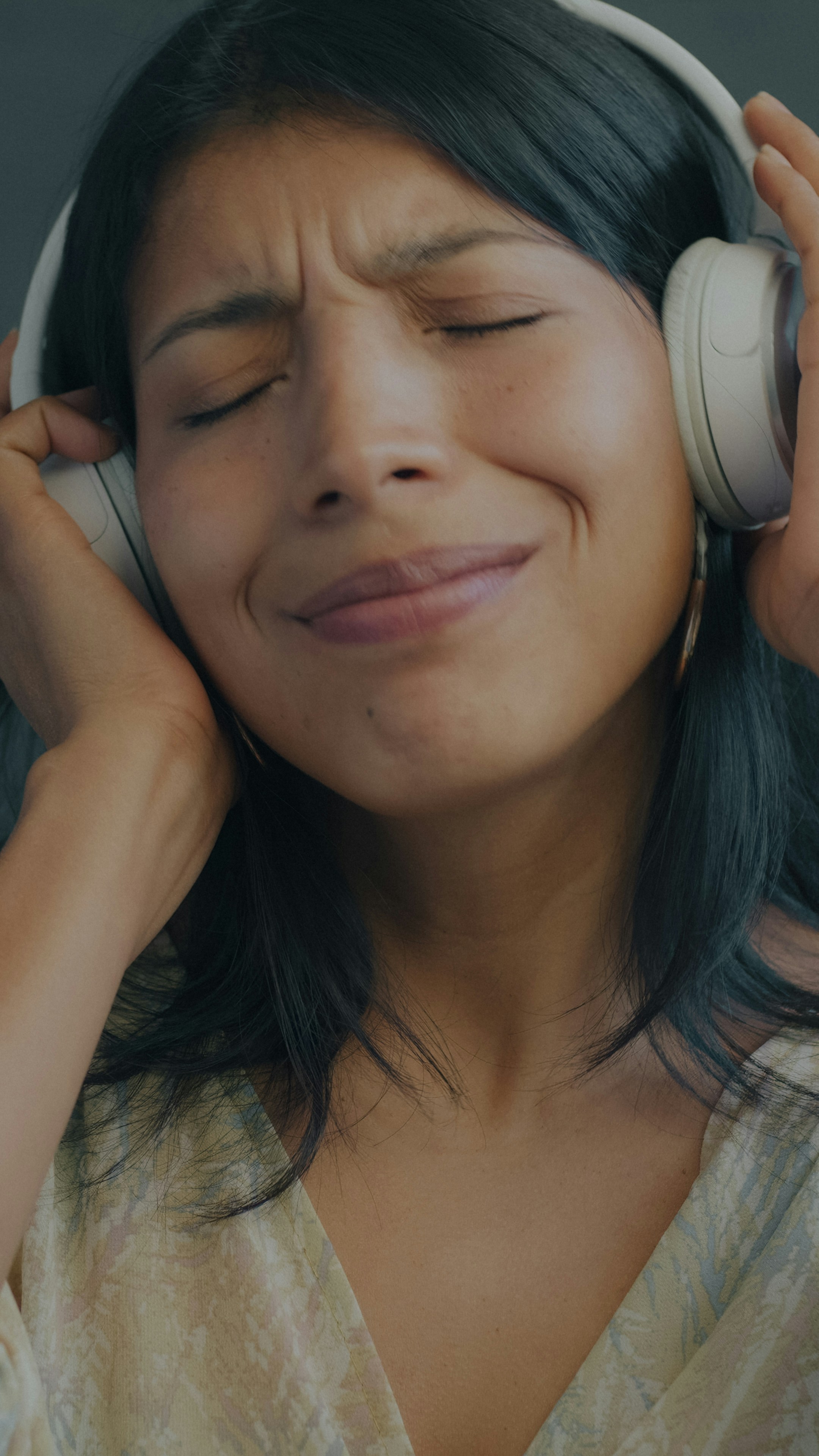 Woman listening to music with headphones, eyes closed