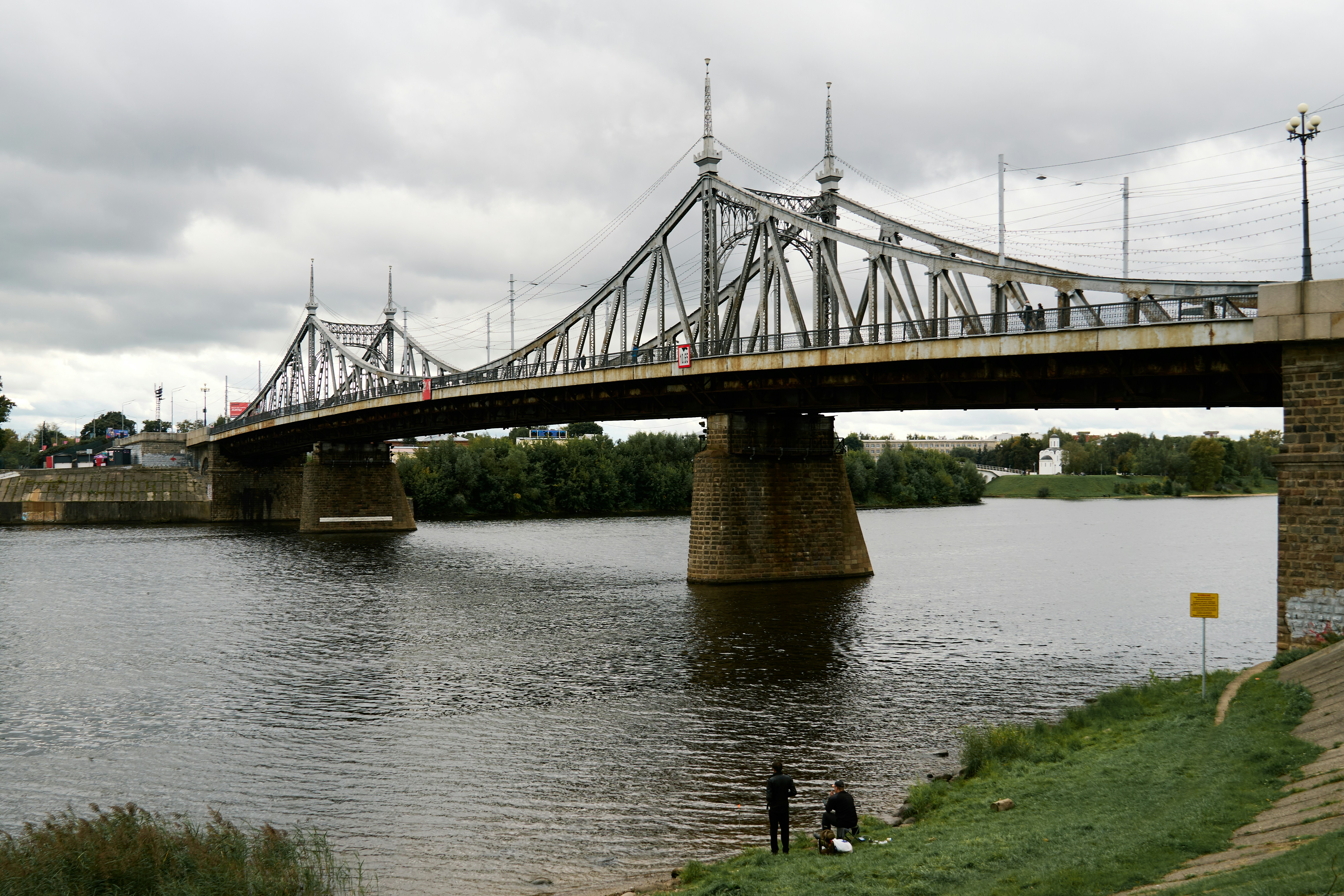 Steel truss bridge over river with two people - historic bridges