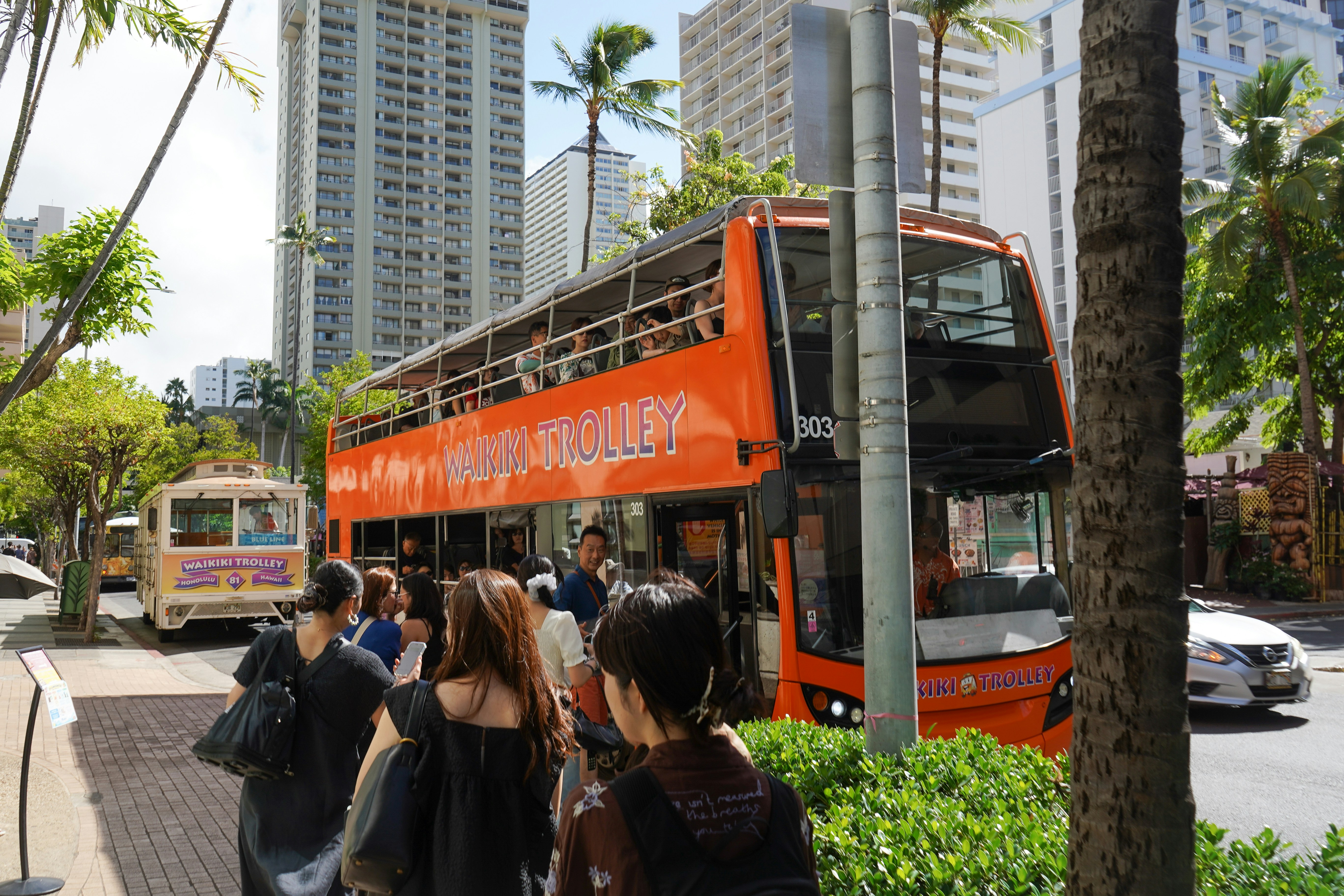 Waikiki Trolley with Tourists in Honolulu, Hawaii
