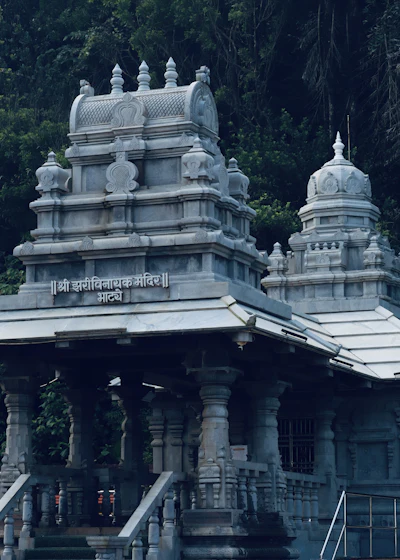 Old stone temple among trees in Konkan