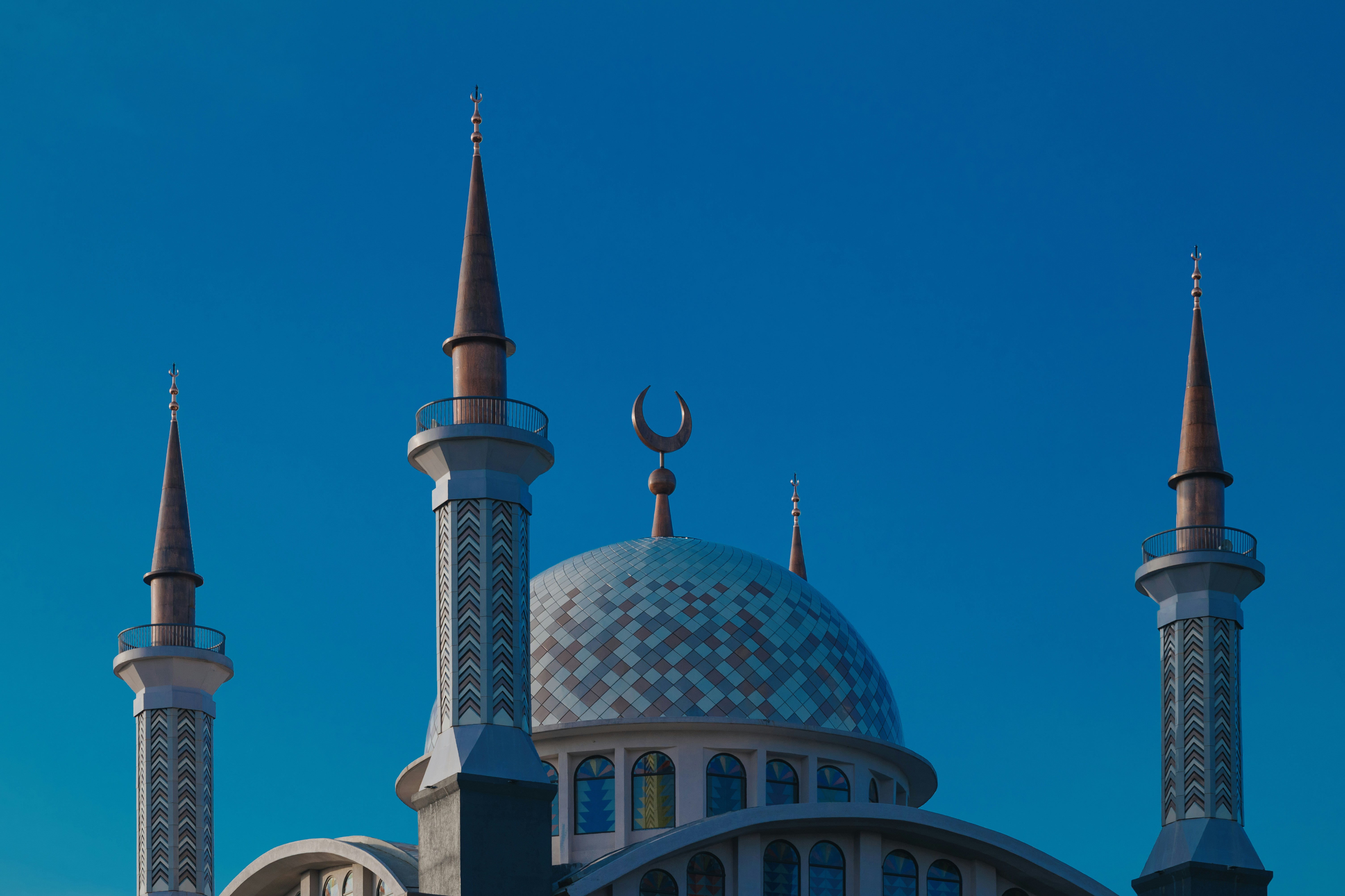 The blue patterned dome of Masjid Nurul Wathon in Bogor with tall pointed minarets
