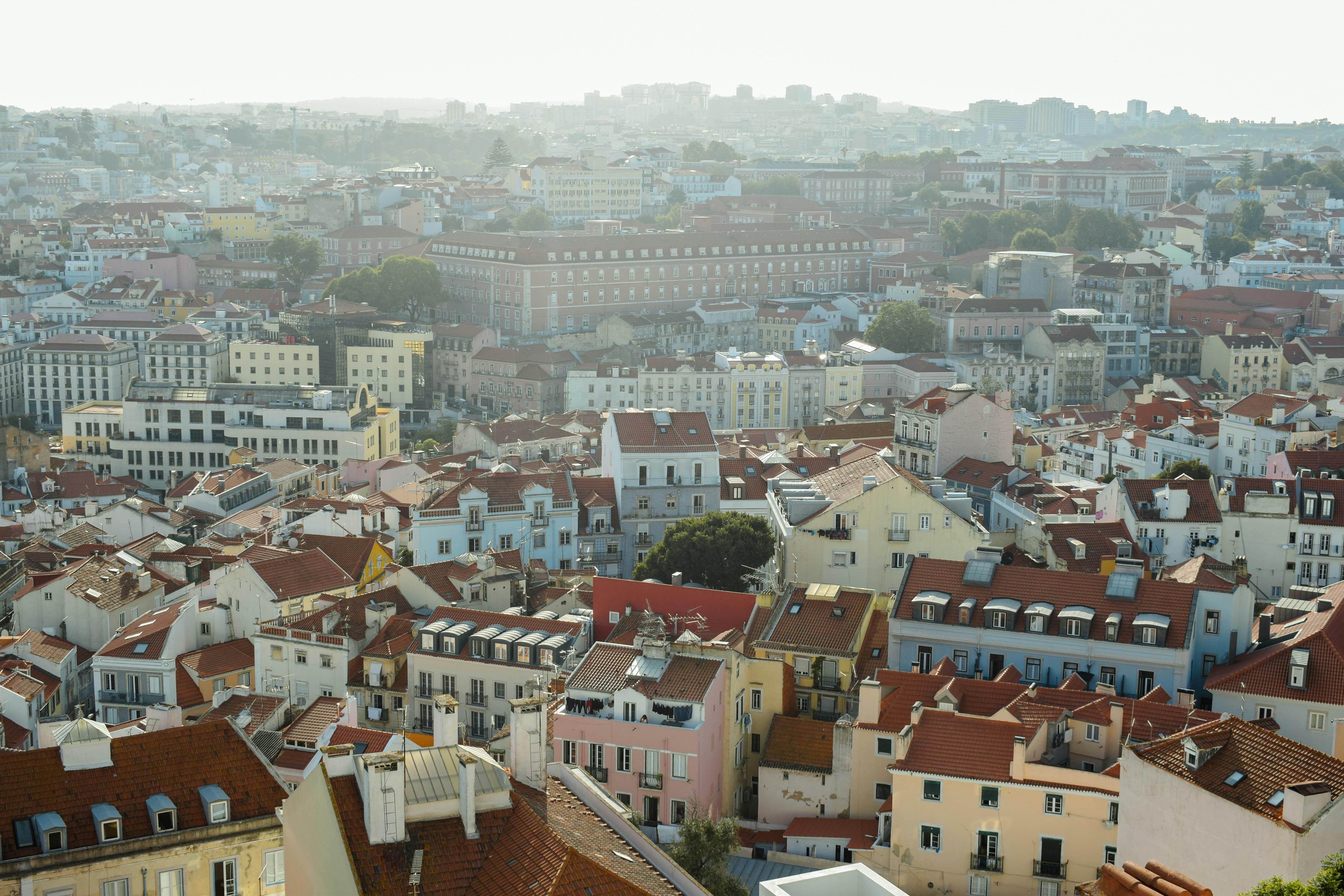 High angle view of dense city buildings with terracotta roofs in Lisbon, Portugal