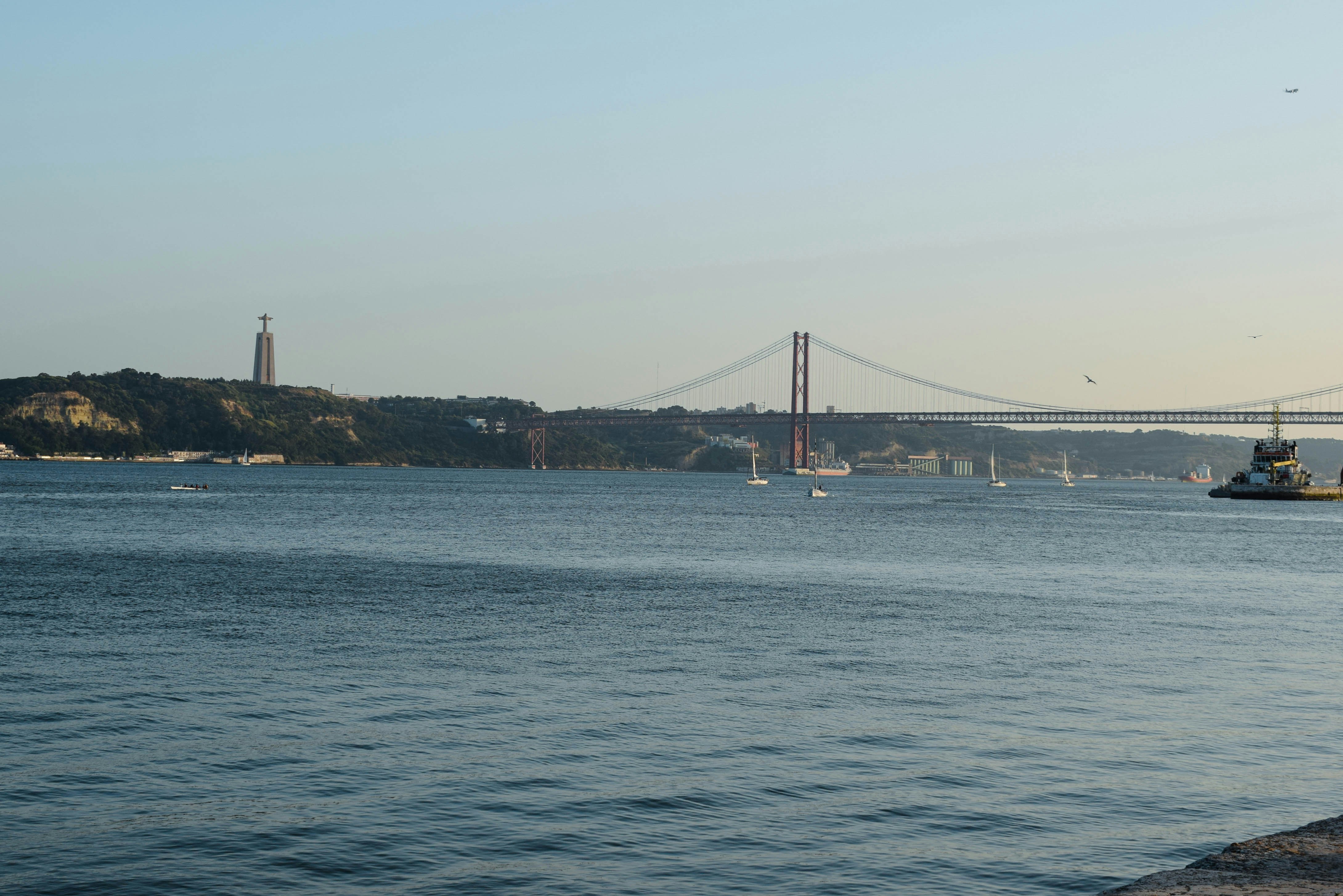 The 25 de Abril Bridge and Christ the King statue in Lisbon, Portugal