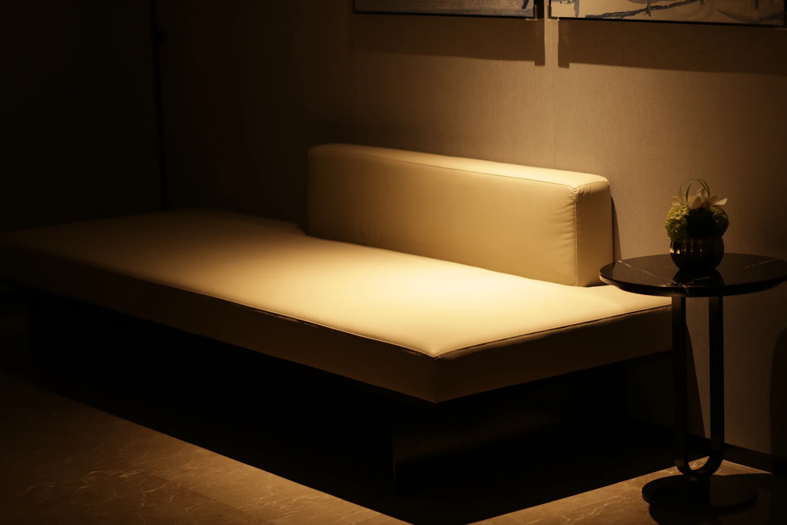 Cream daybed in a dimly lit relaxation room