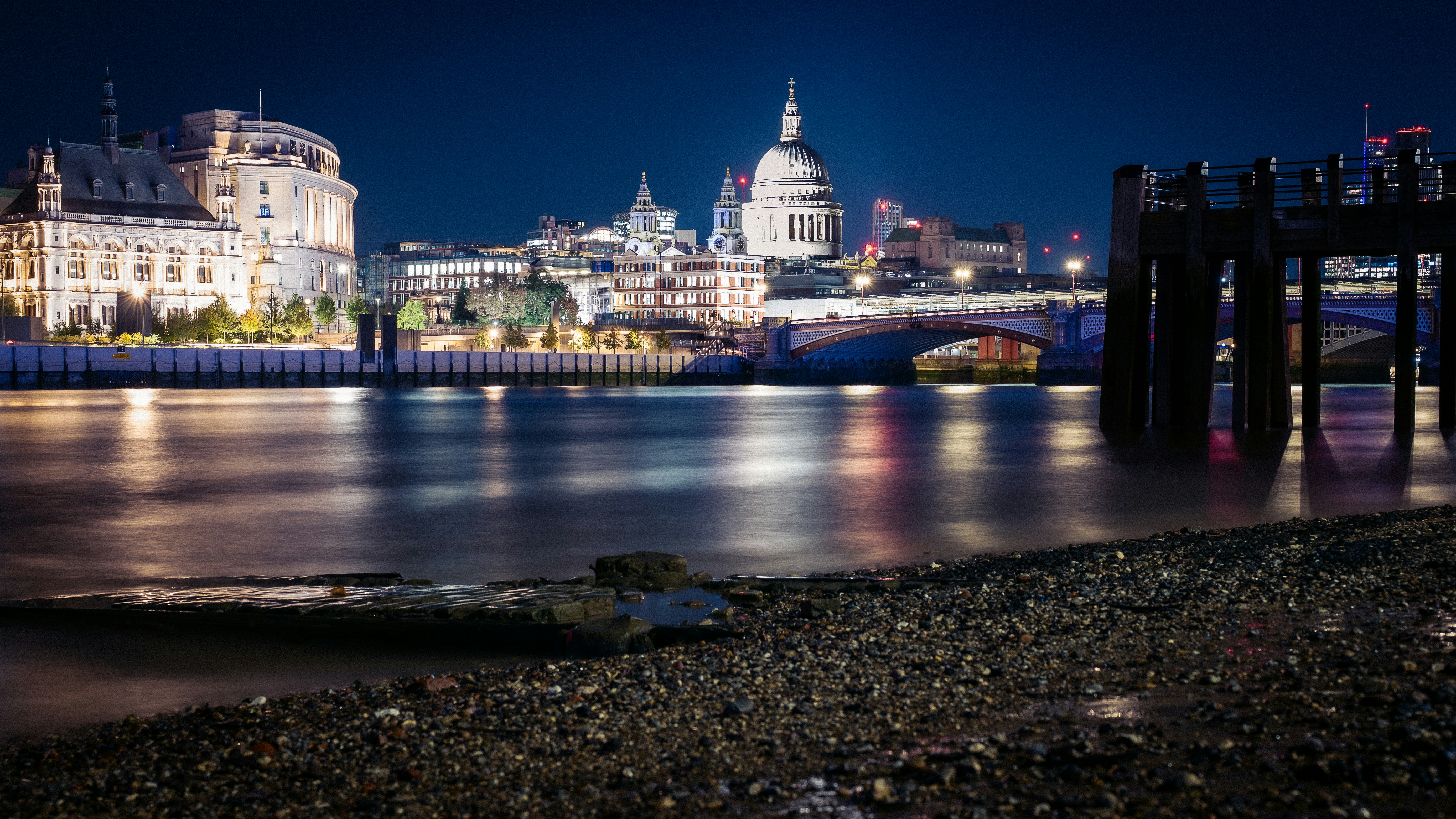 St Paul's Cathedral and the London skyline reflected in the River Thames at night