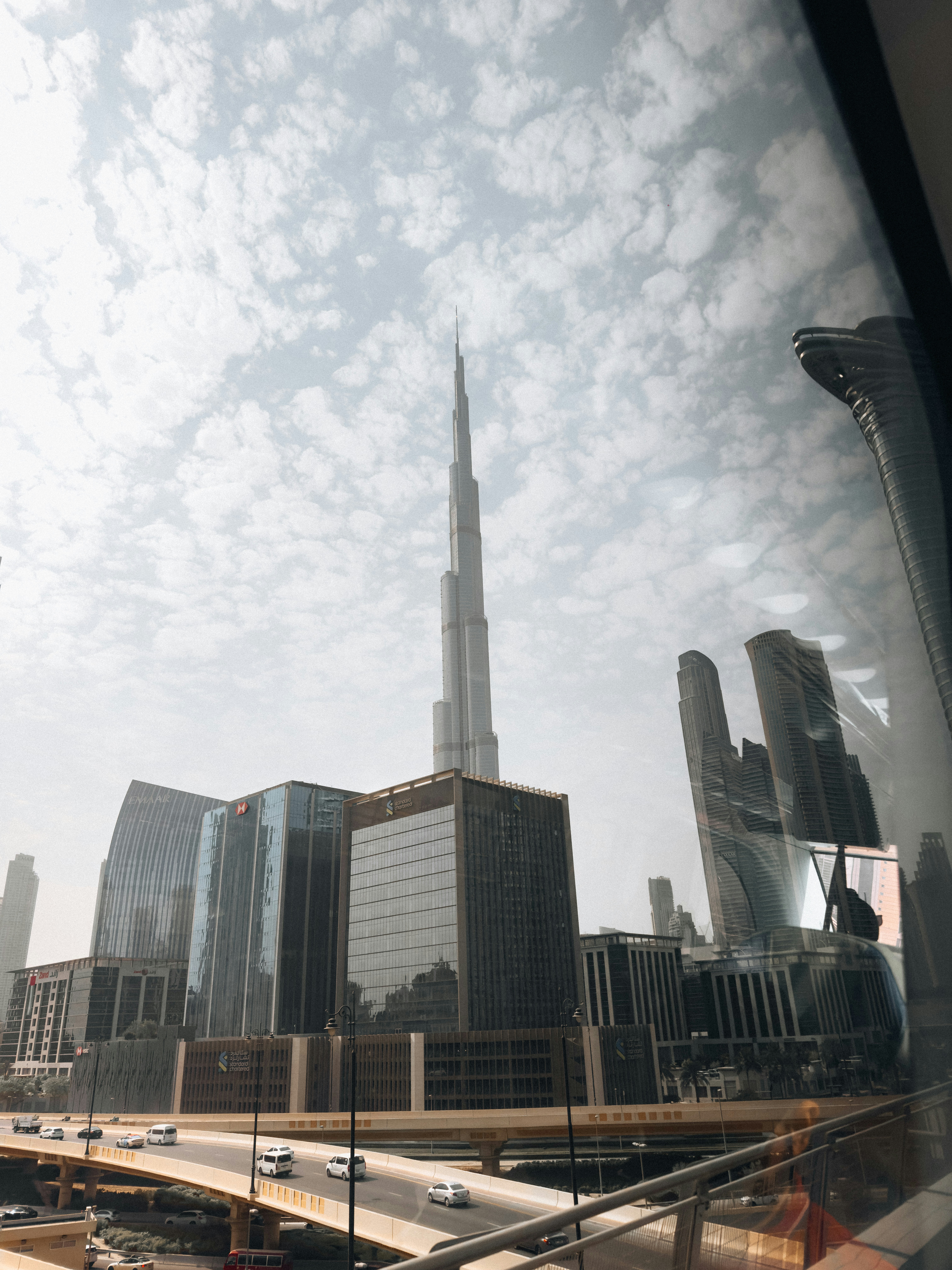 The Burj Khalifa rising above the modern skyline and elevated highway in Dubai