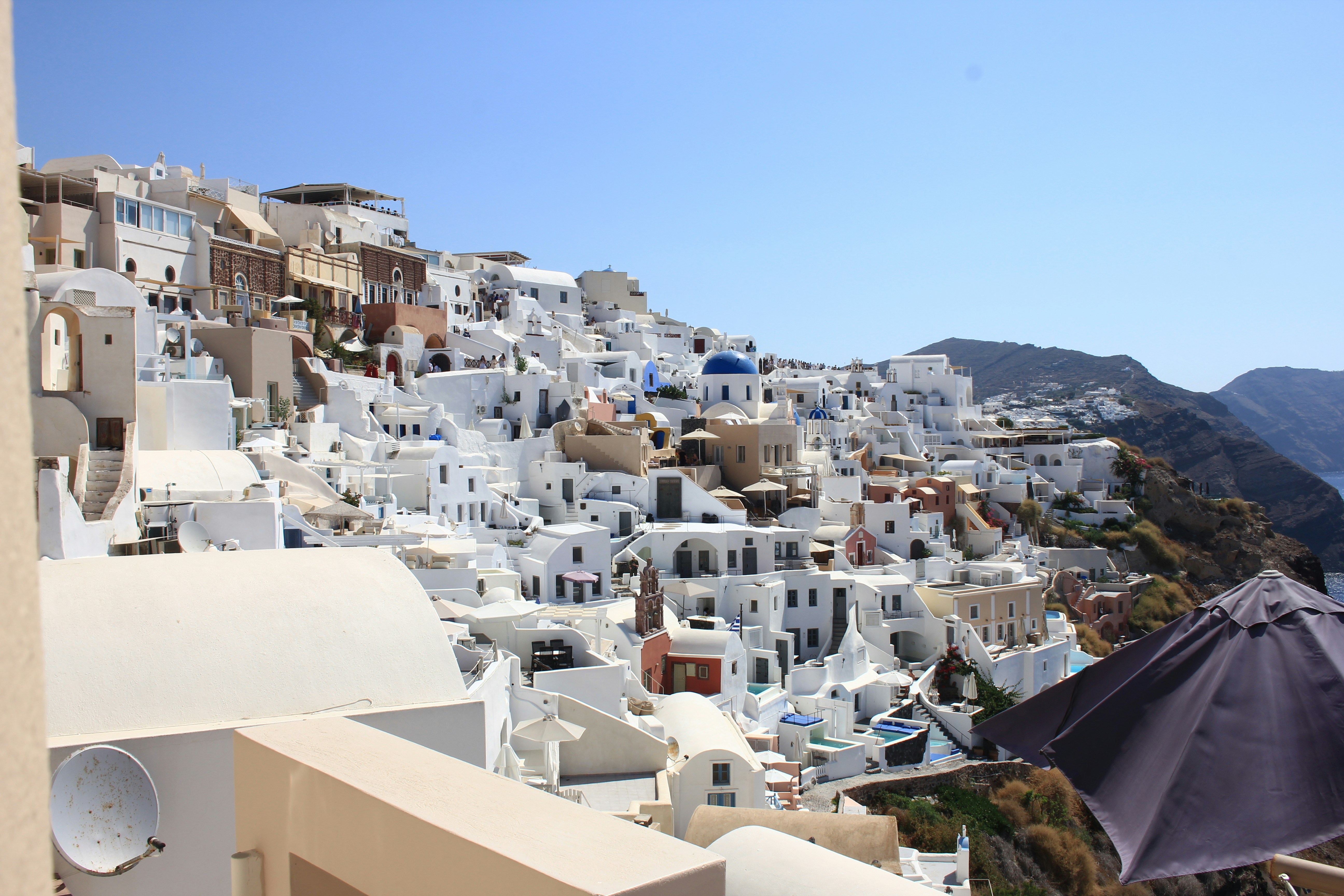 White buildings with blue domes on a cliffside in Oia, Santorini