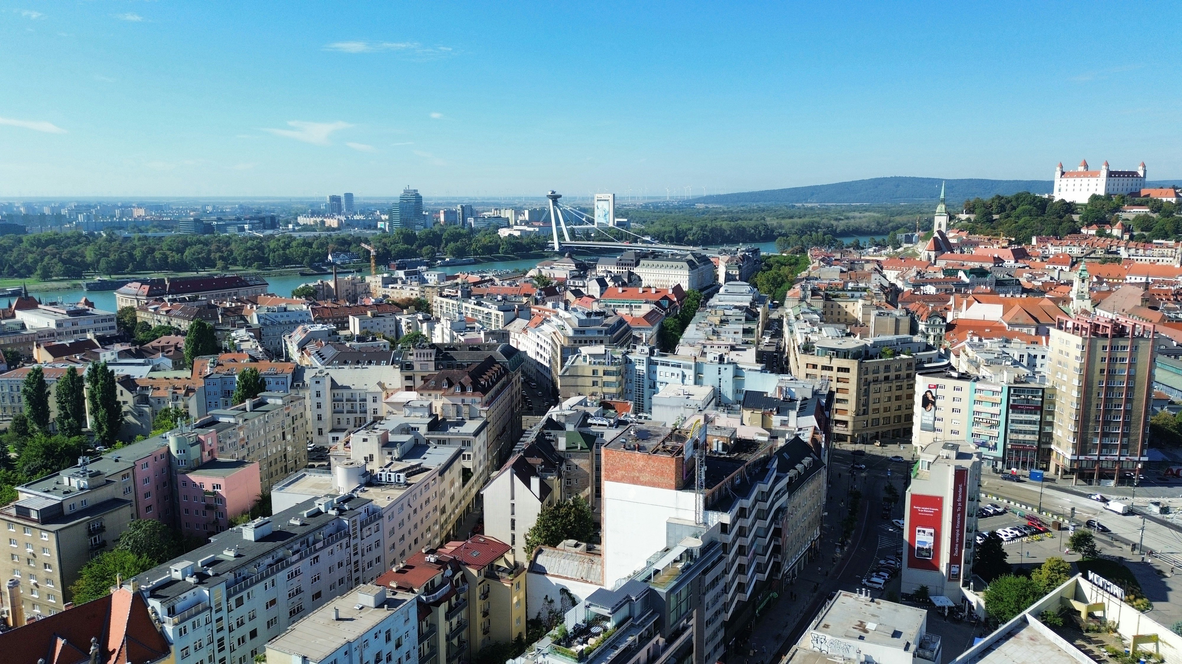 Aerial view of Bratislava with the Danube river and castle under a clear sky