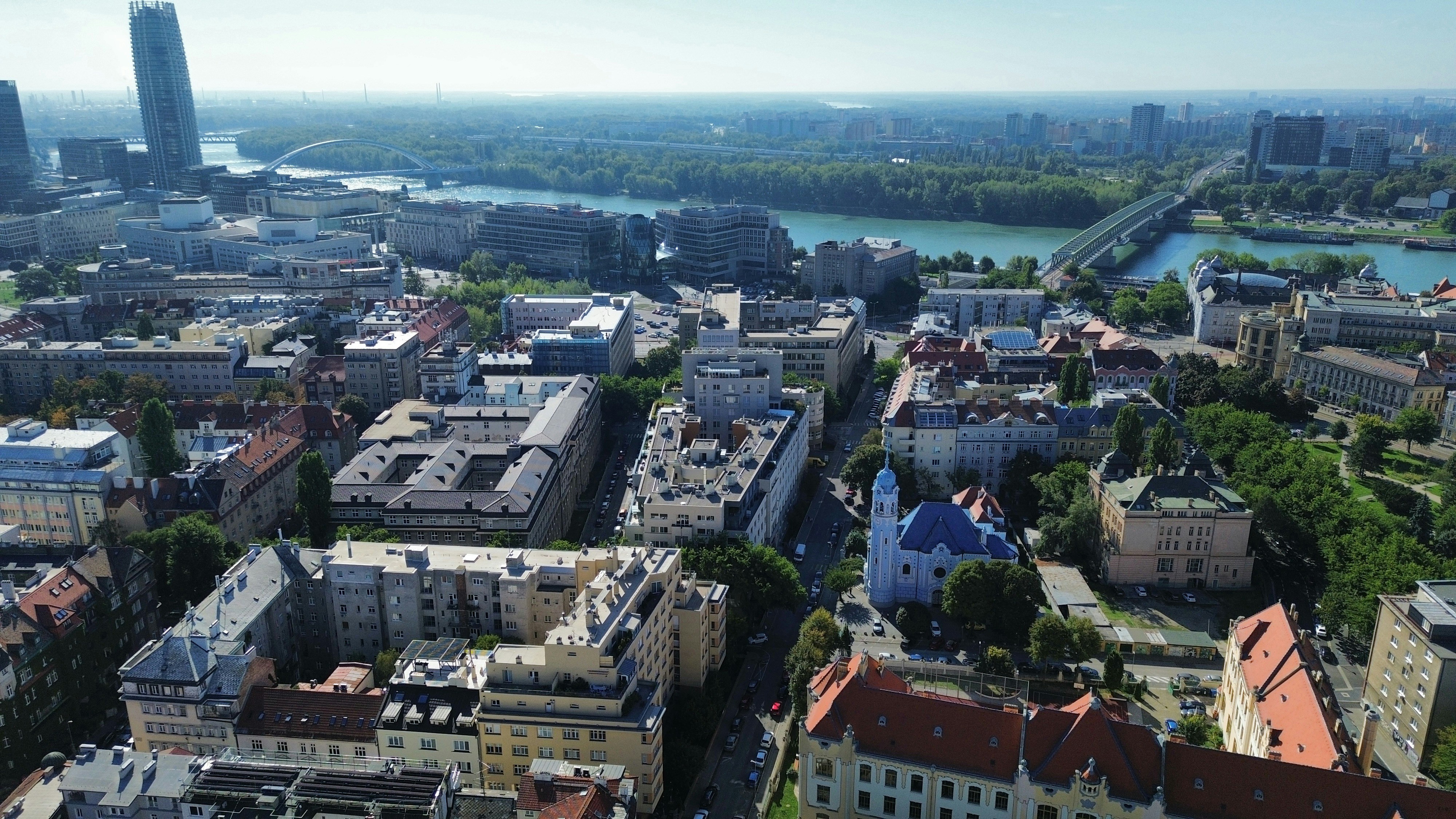 Aerial view of the city of Bratislava with the Danube river and blue church