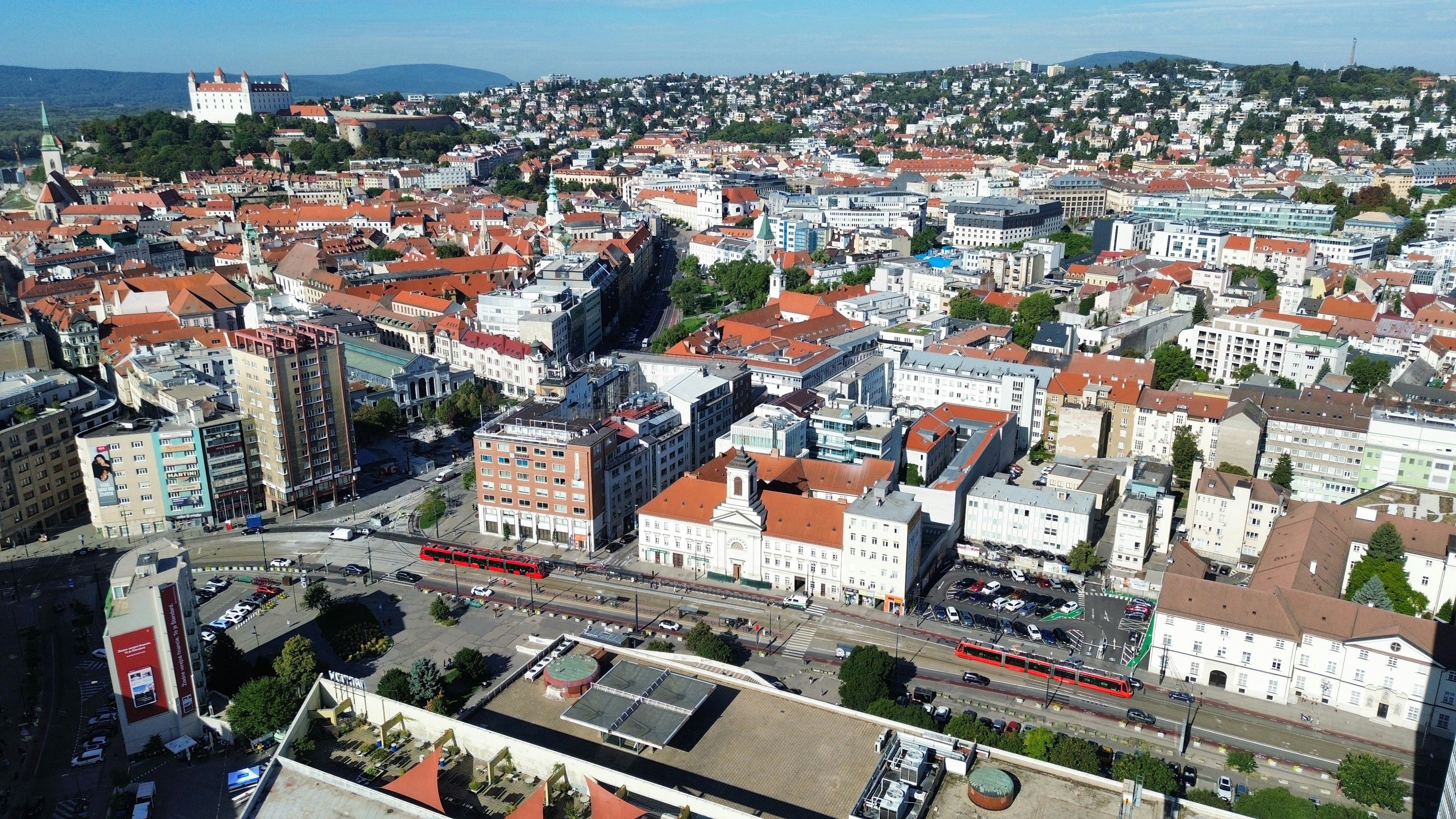 Aerial view of Bratislava with the castle on a hill and red trams