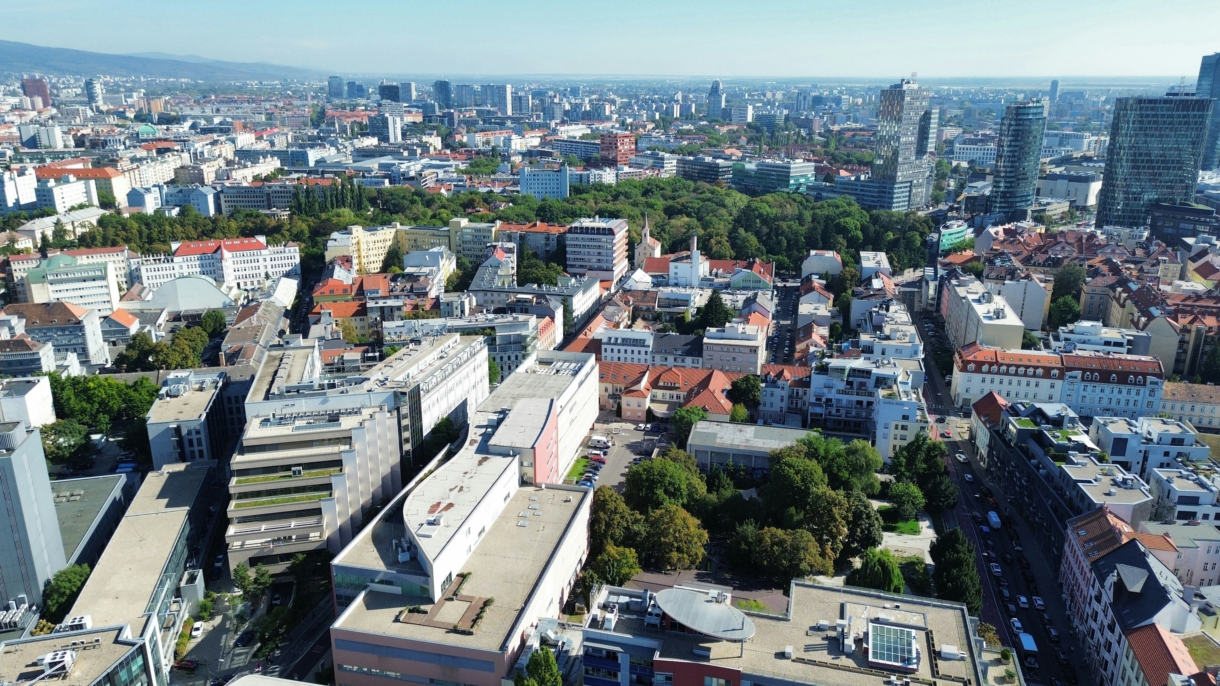 Aerial view of a dense city with modern skyscrapers and residential buildings