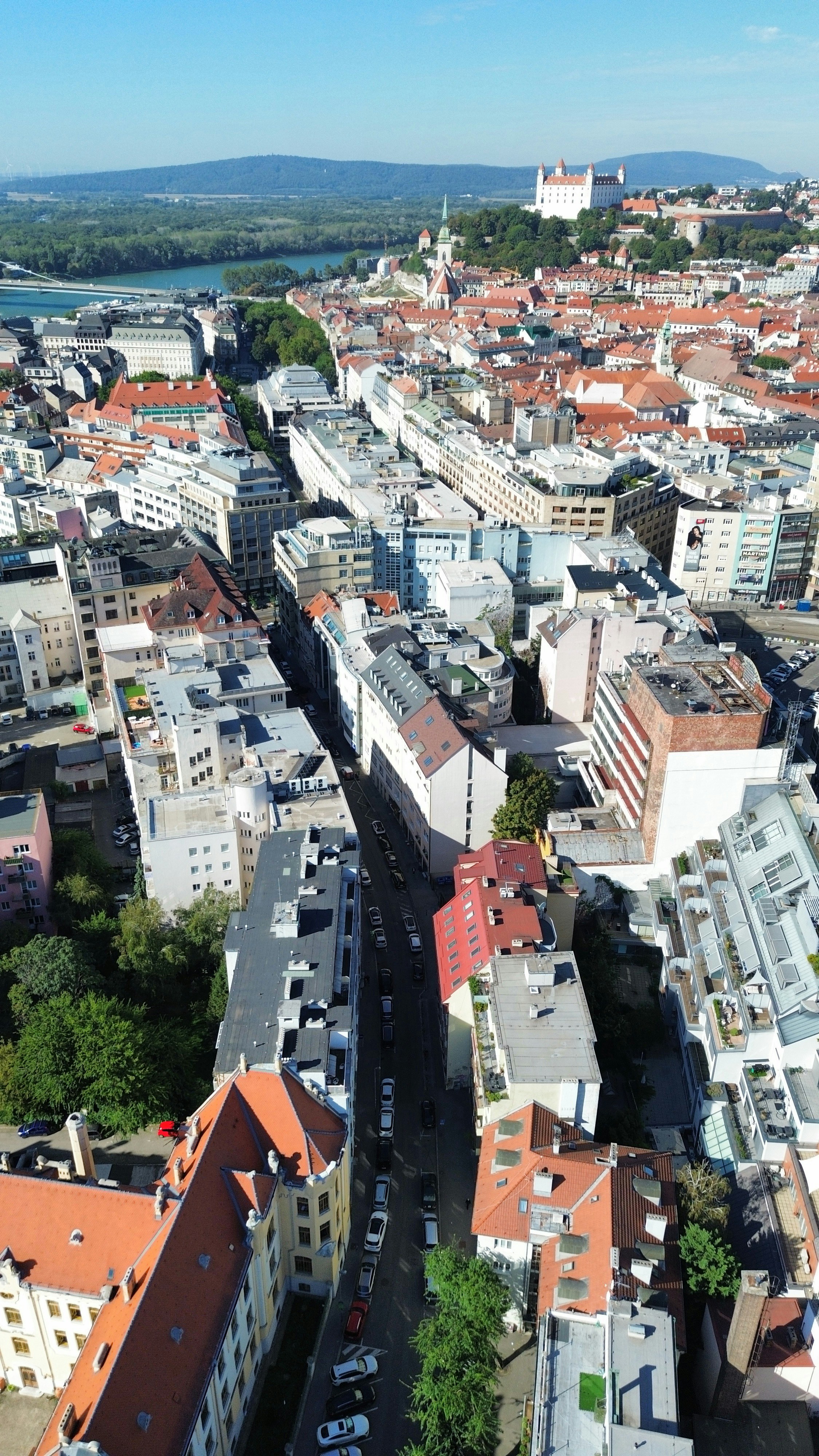 Aerial view of Bratislava with the castle on a hill and red rooftops