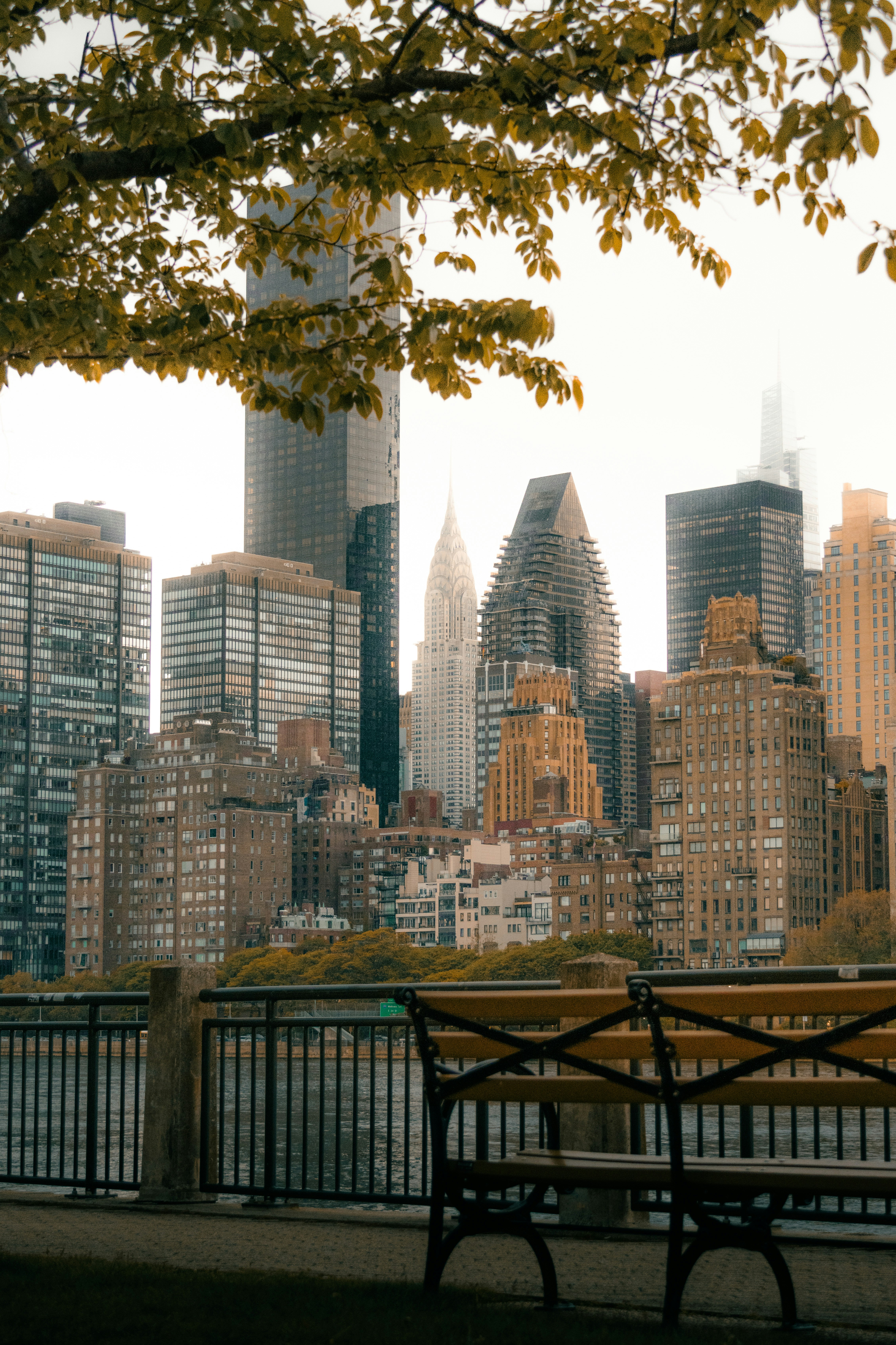 A wooden bench overlooking the Chrysler Building and Manhattan skyline in New York City
