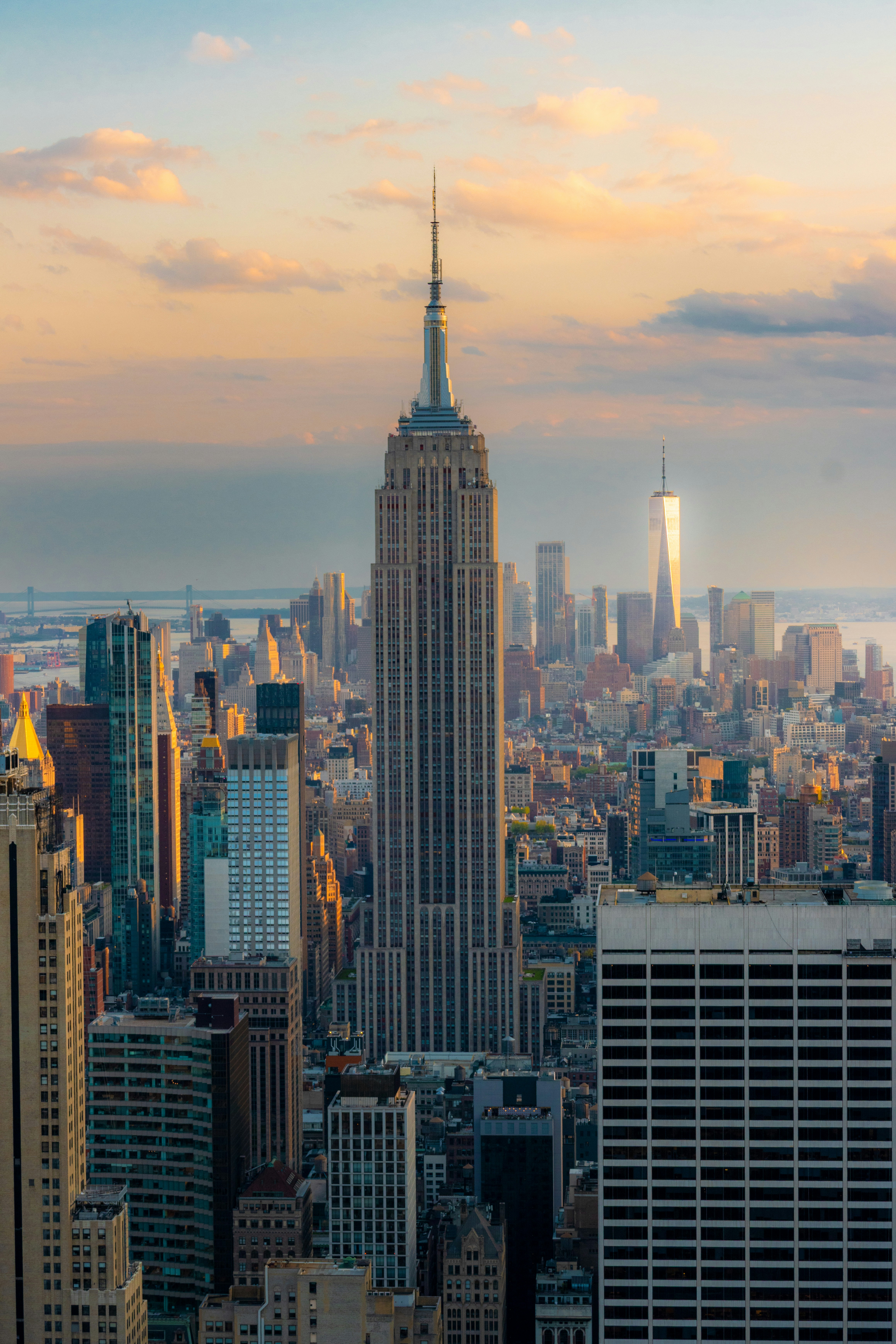 The Empire State Building and New York City skyline under a warm golden sky