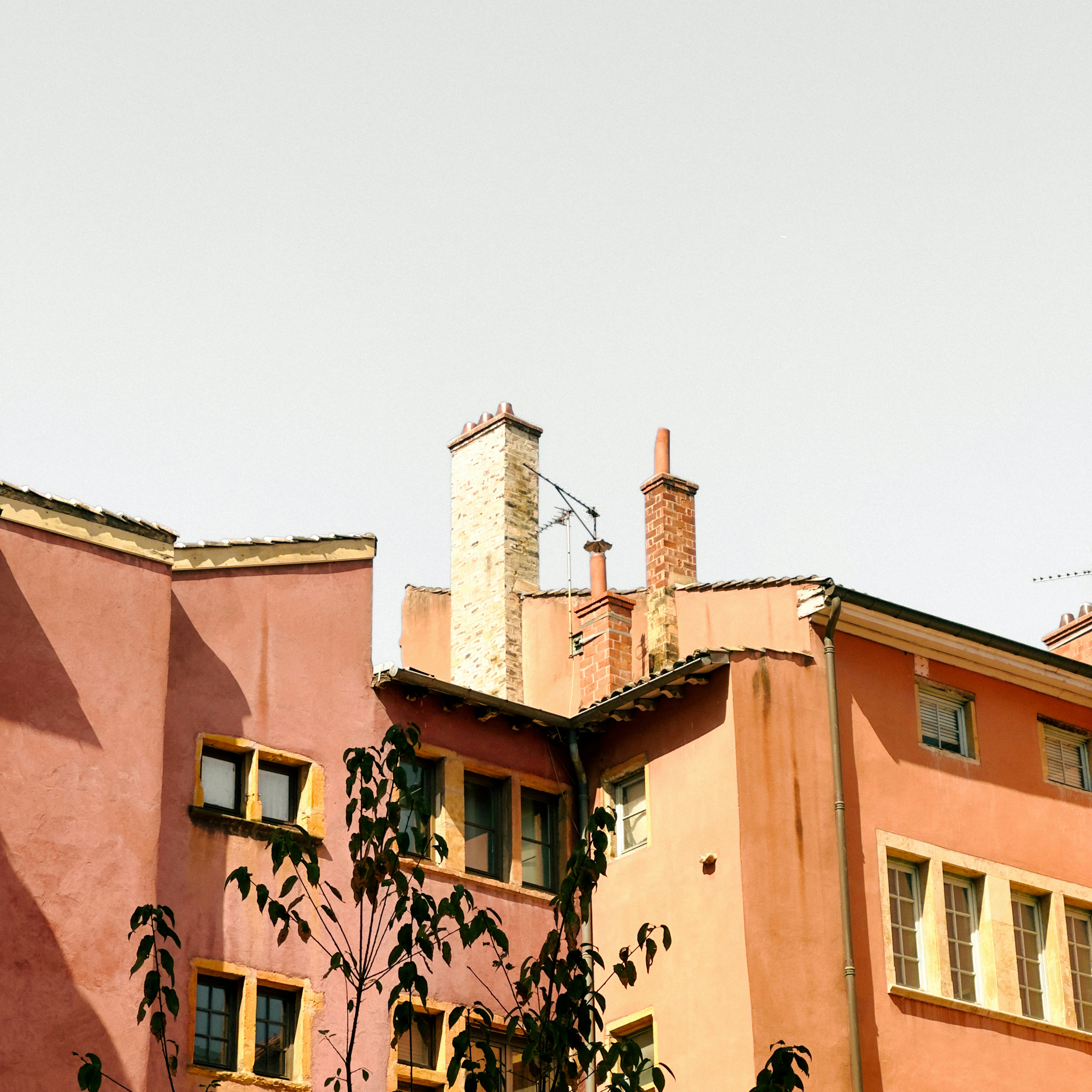 Pink stucco buildings with chimneys - Free Photo on Unsplash