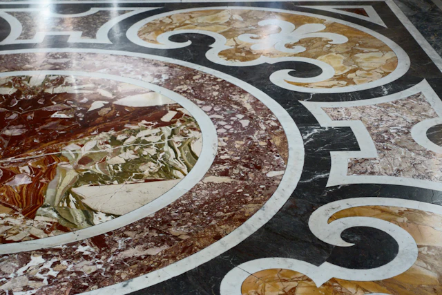 Round marble floor medallion inlaid in red, green and yellow