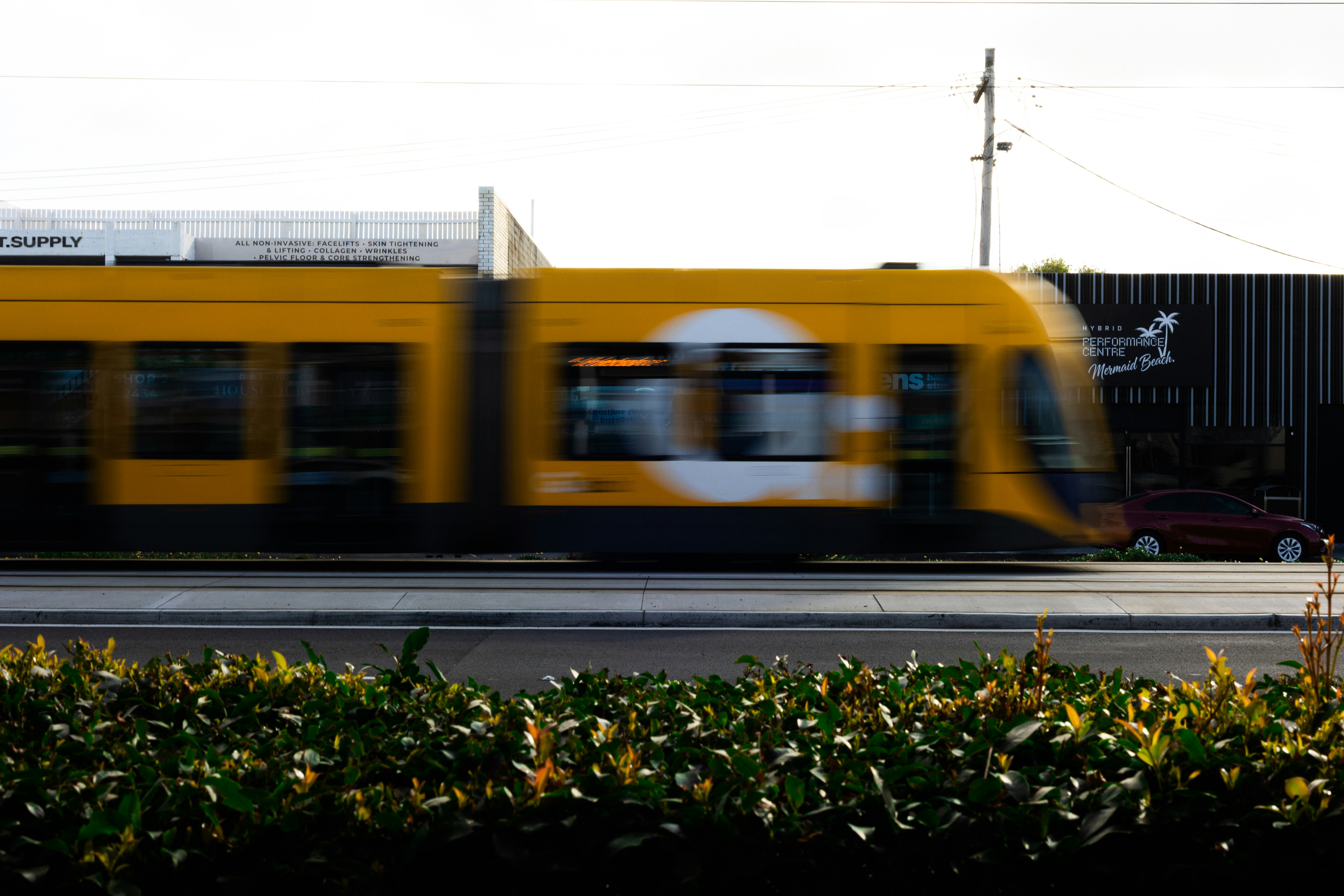 Yellow tram moving past in motion blur