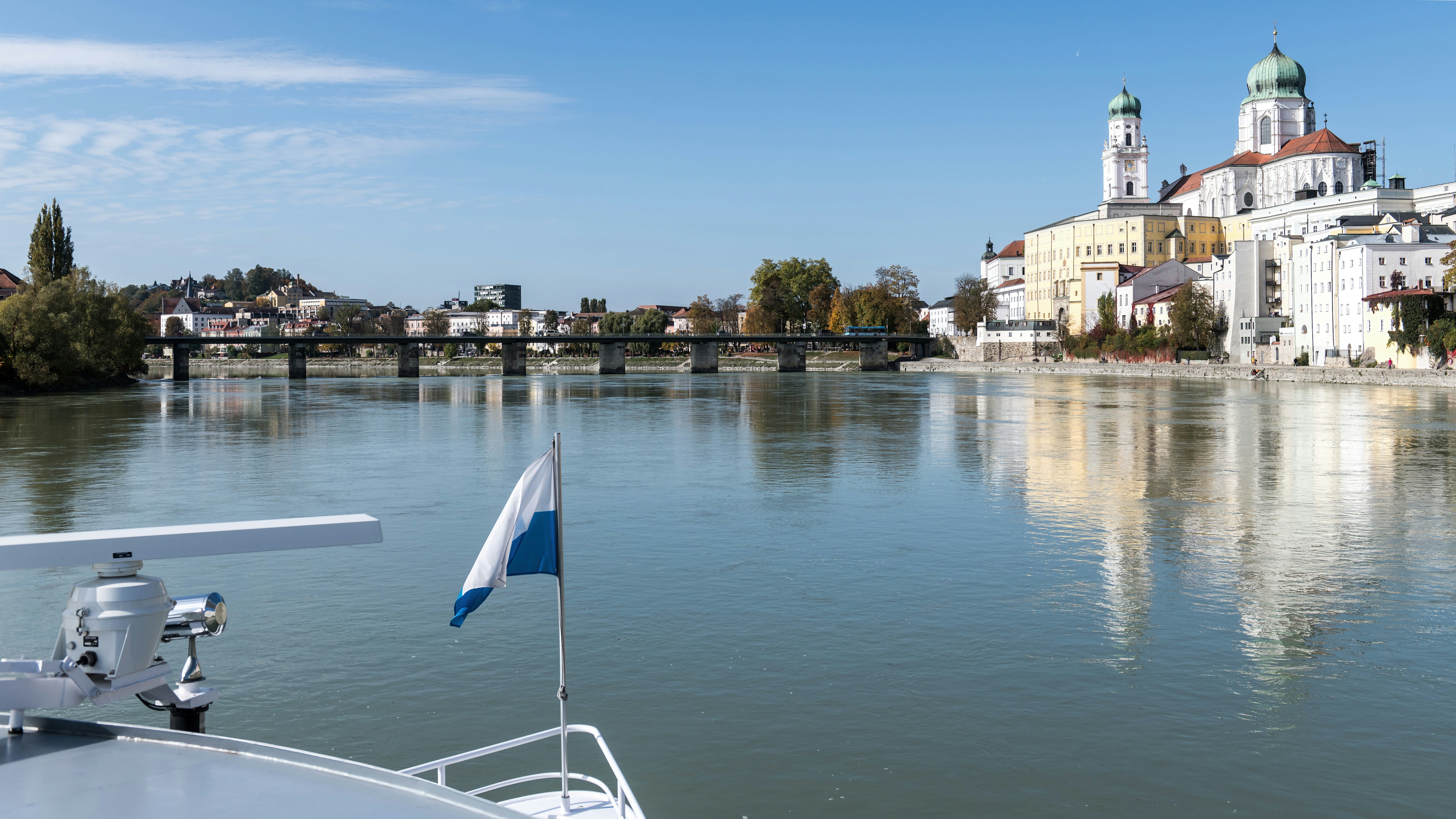 A view from a boat deck toward the Passau skyline and Danube river