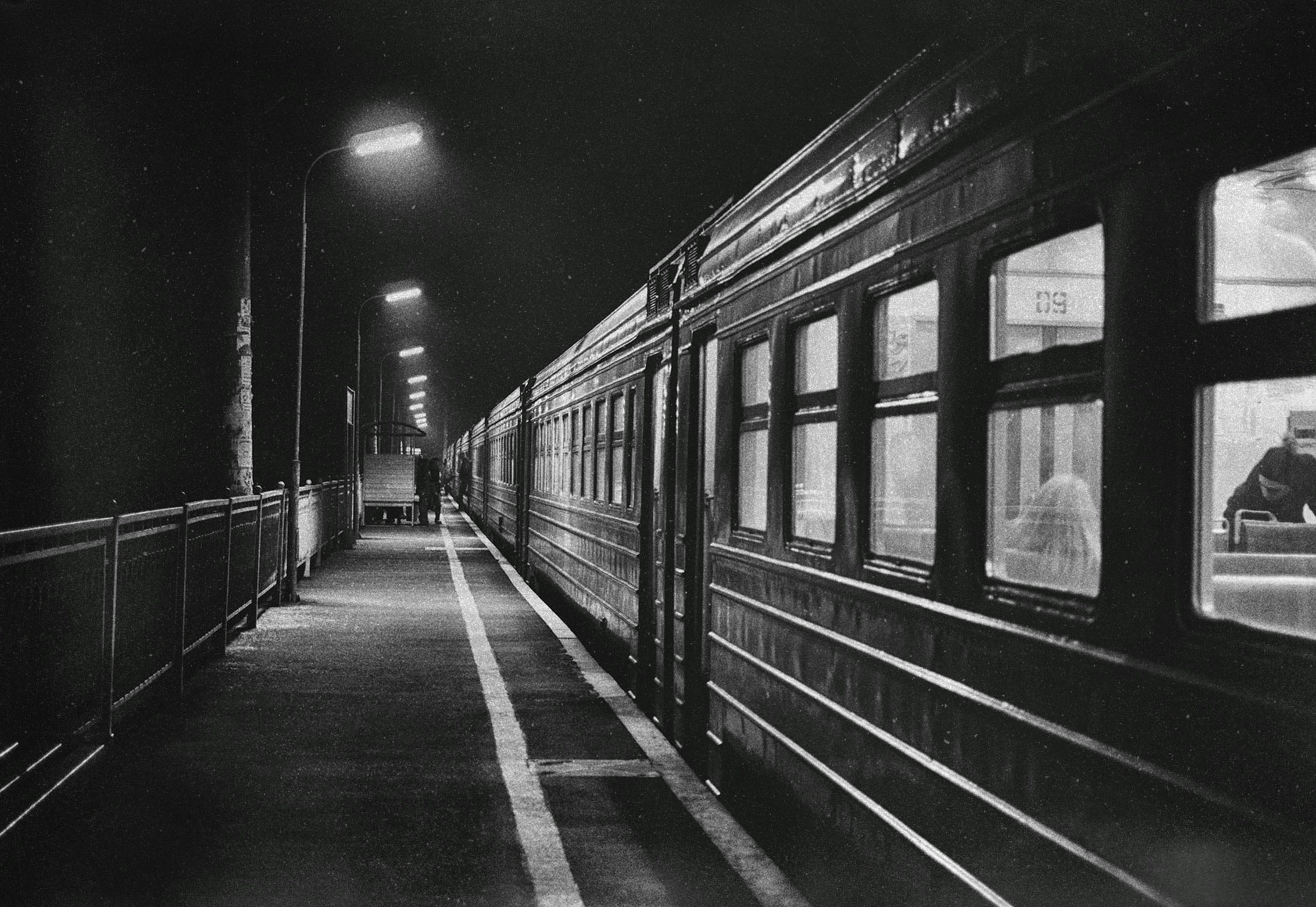 Train at a dimly lit platform at night