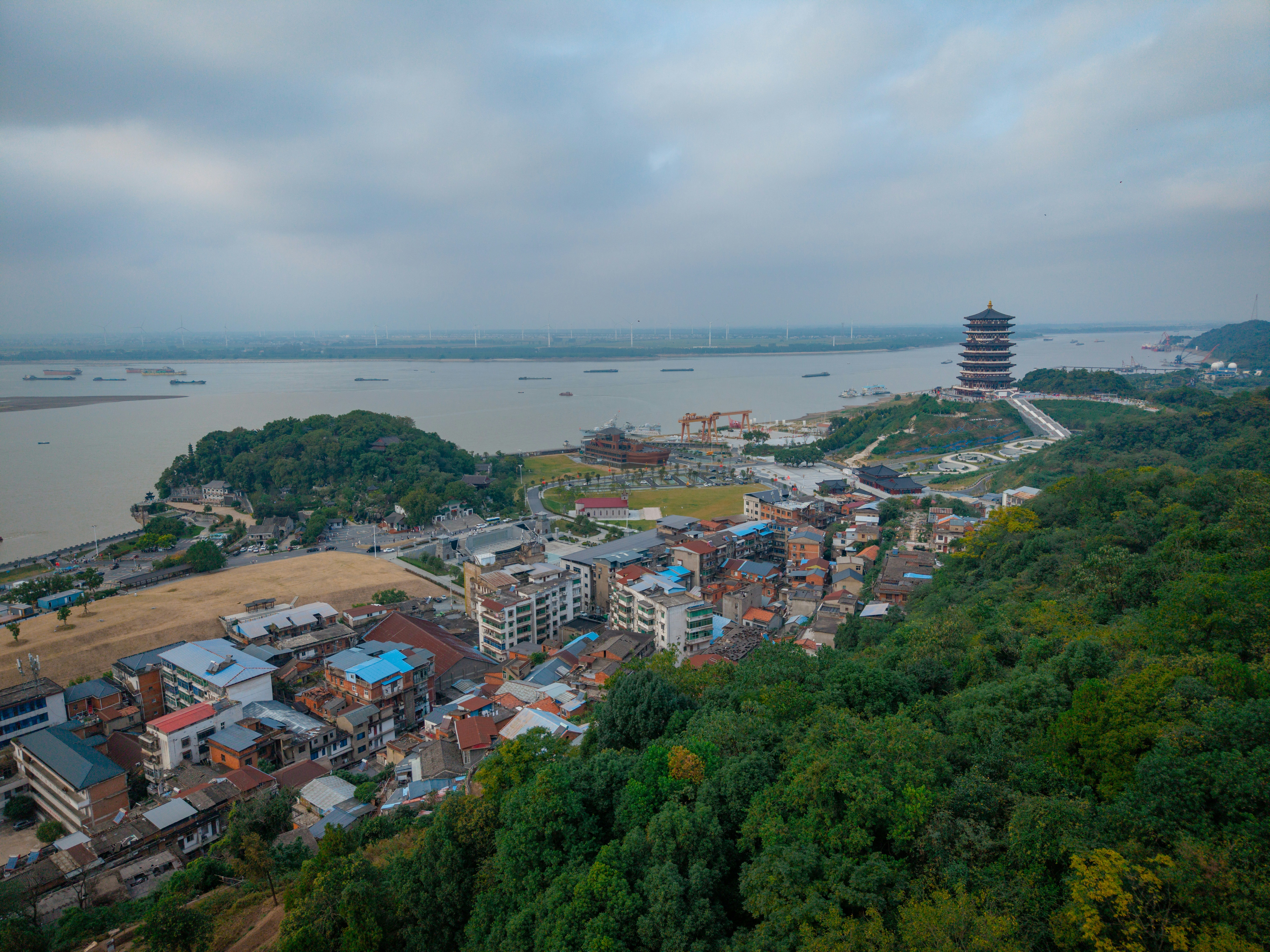 Aerial view of a pagoda overlooking a river and a town in Jiujiang