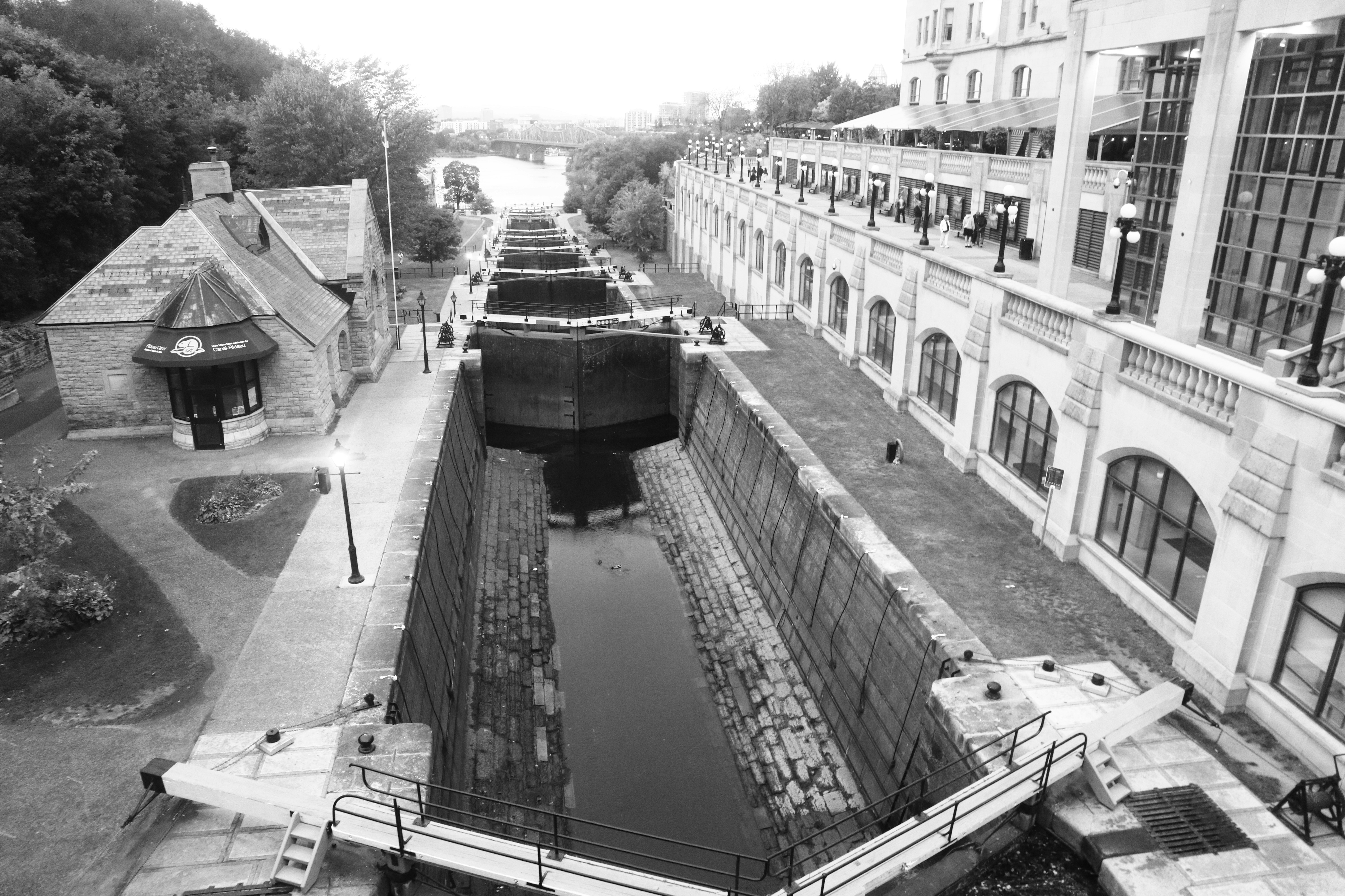 The Rideau Canal locks in Ottawa with stone walls and a historic building