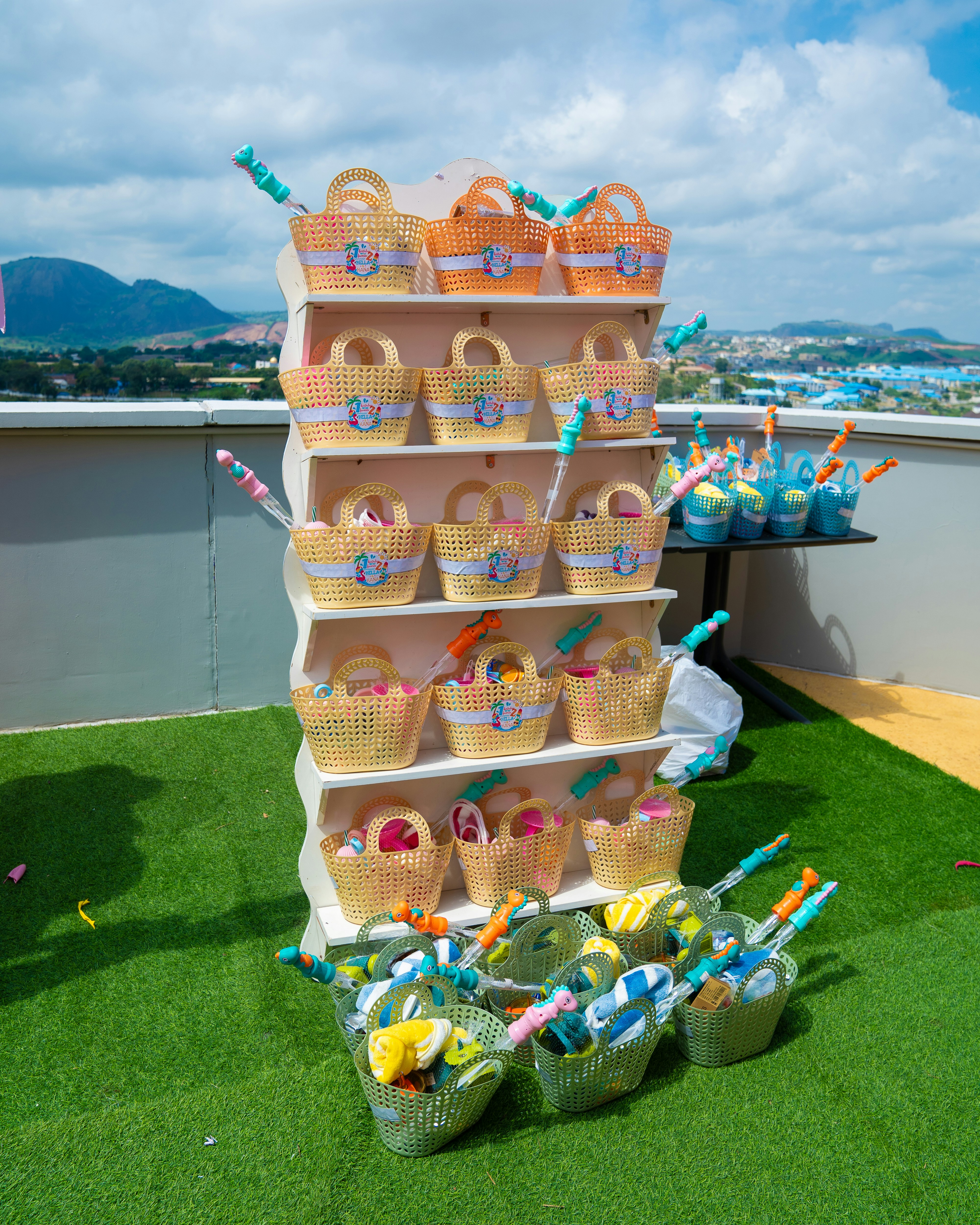 Woven plastic baskets filled with colorful toys on a white display shelf outdoors