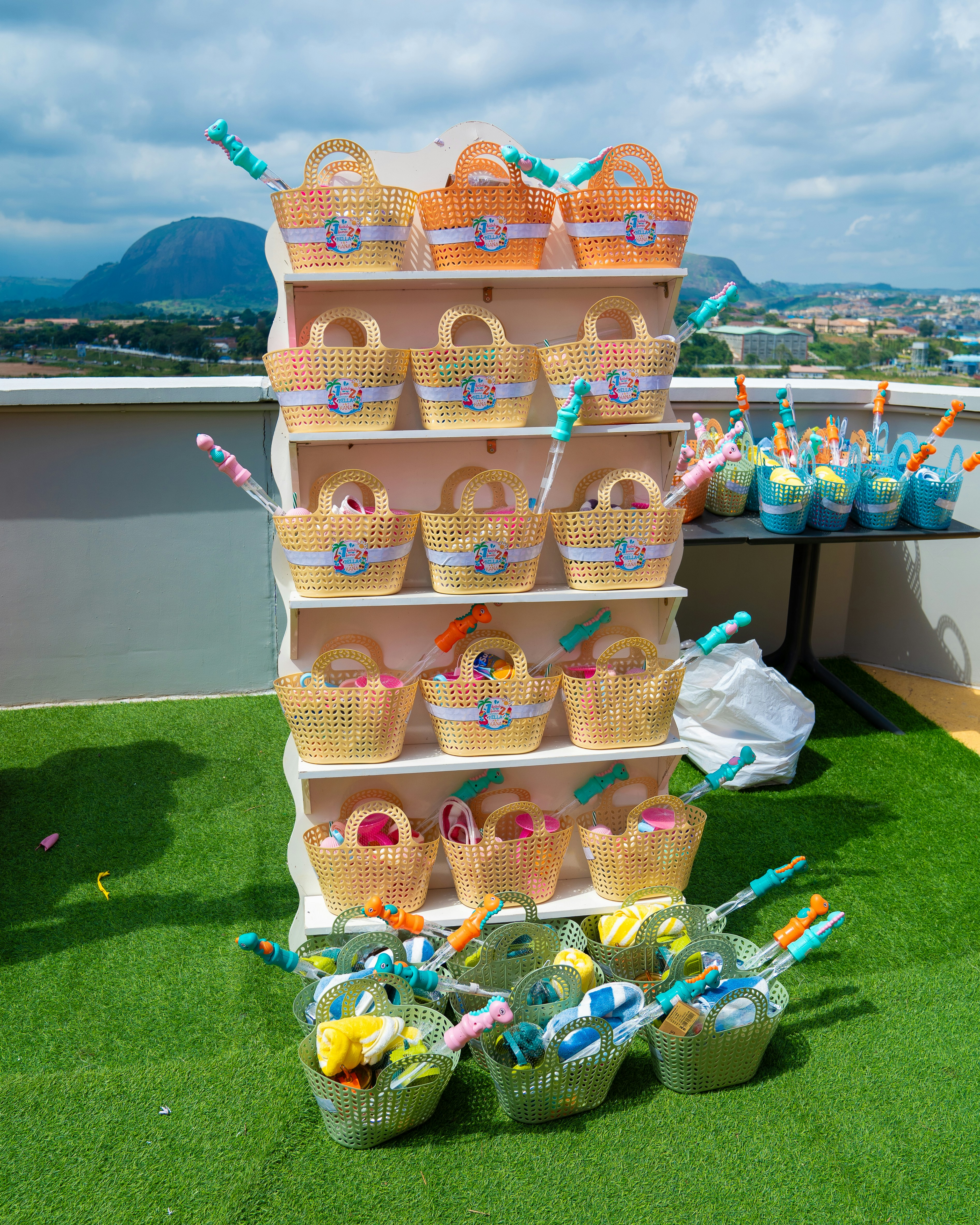 Woven plastic baskets filled with toys on a white display shelf outdoors