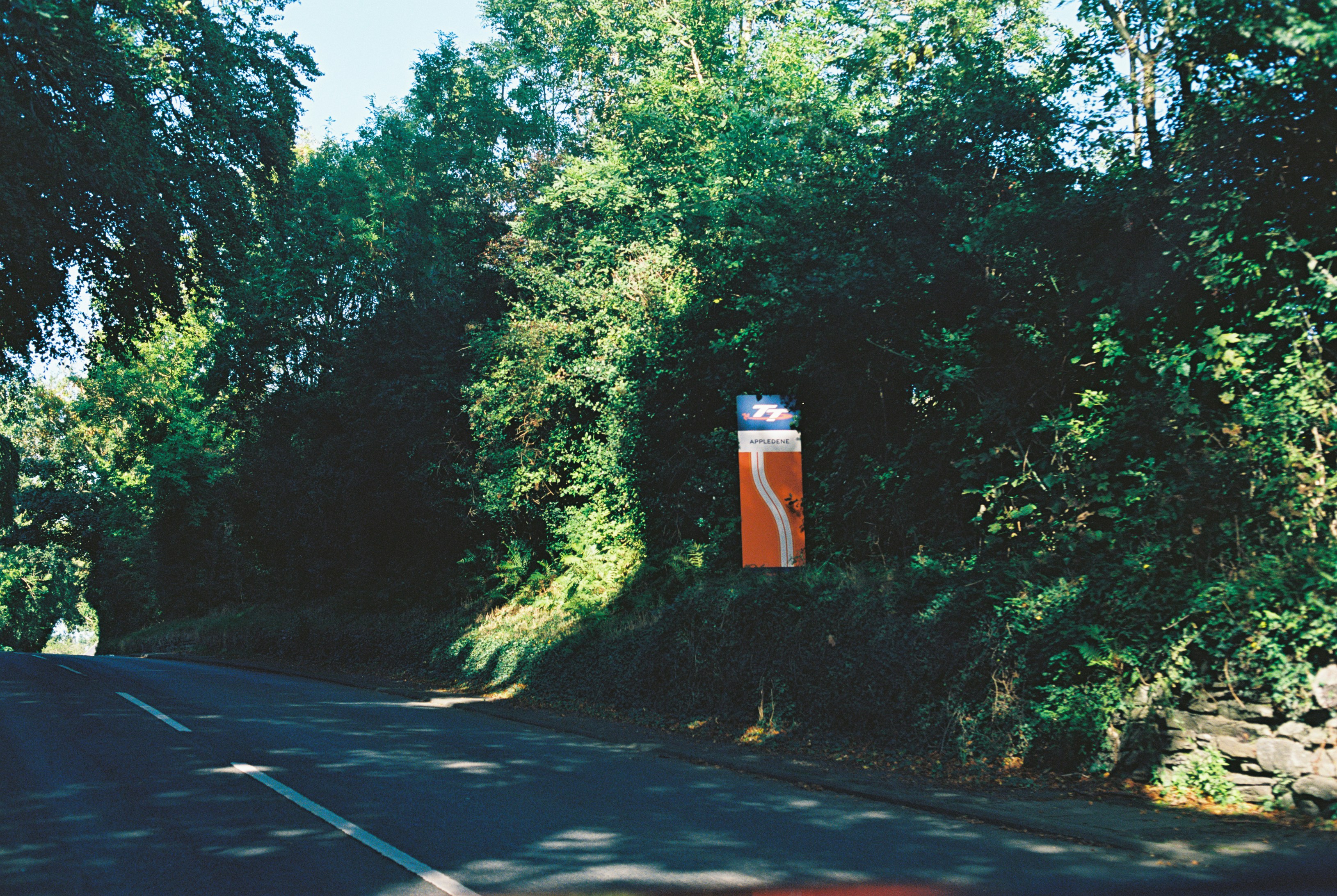 A road sign for Appledene on a tree-lined country road