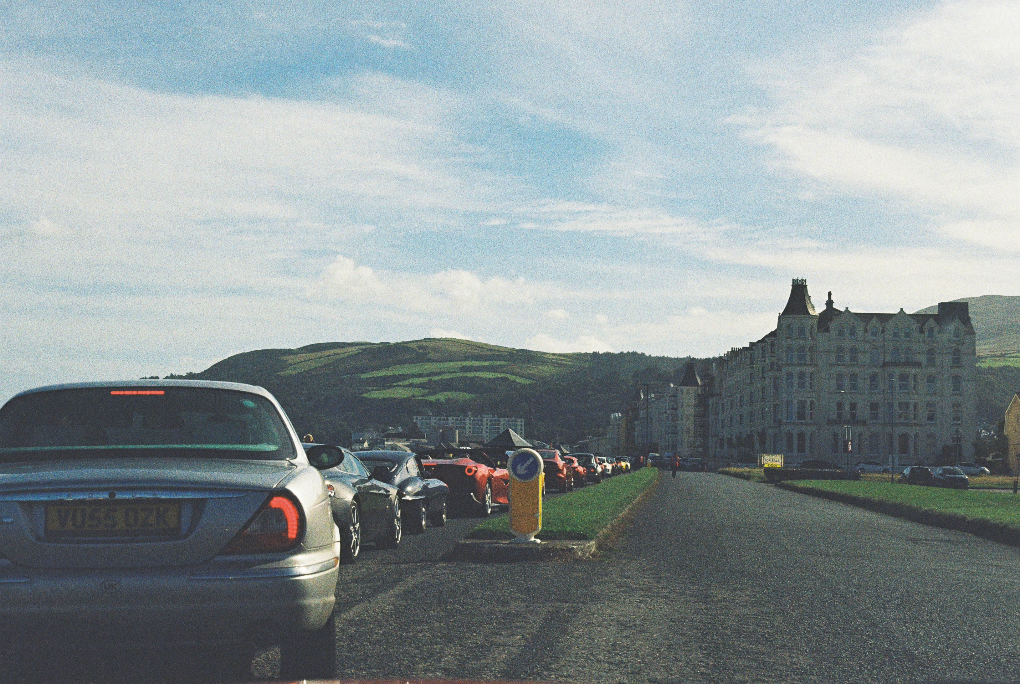 Traveler checking an eSIM data connection on a phone on the Douglas promenade, Isle of Man
