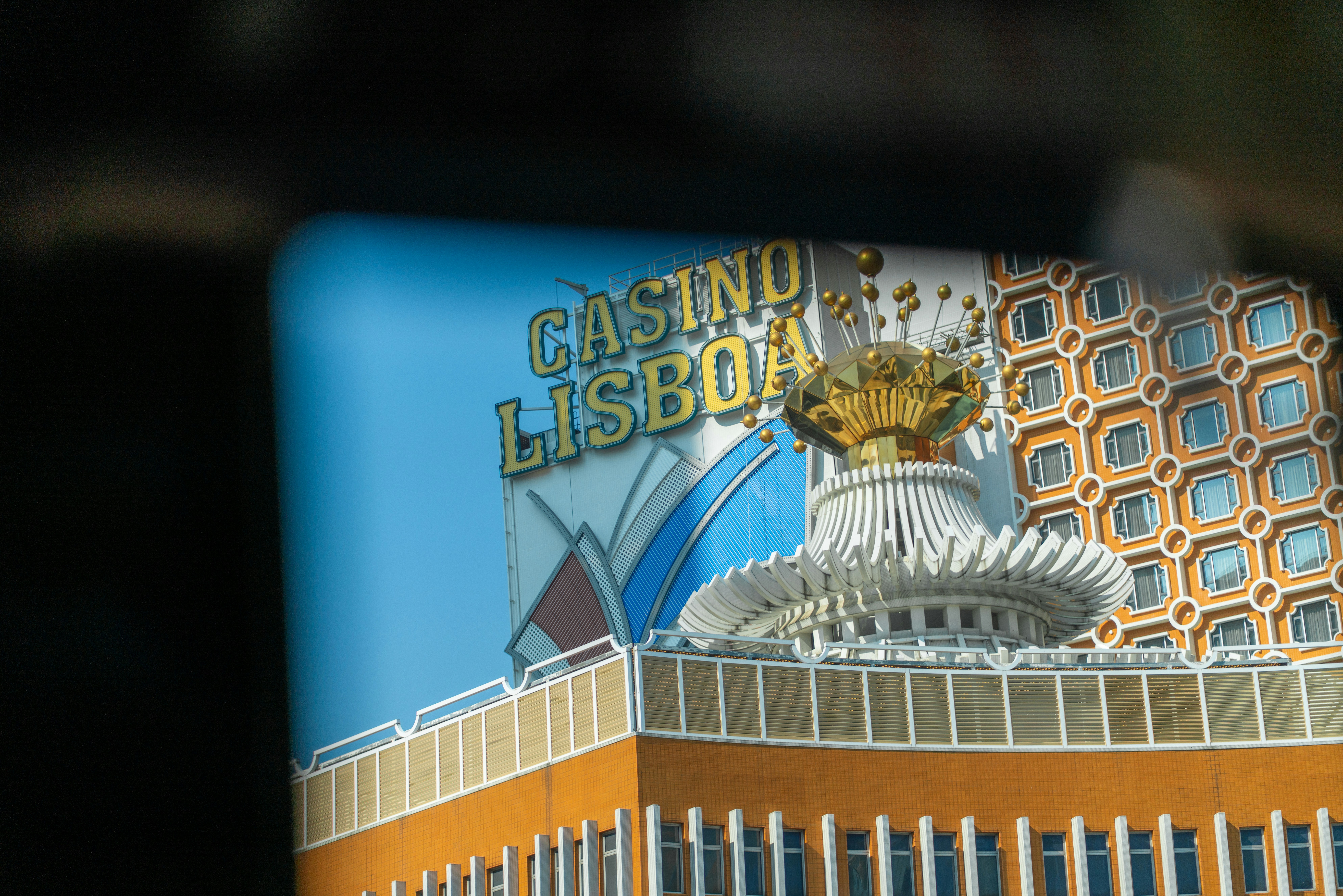 The Casino Lisboa sign atop a building with a gold crown structure