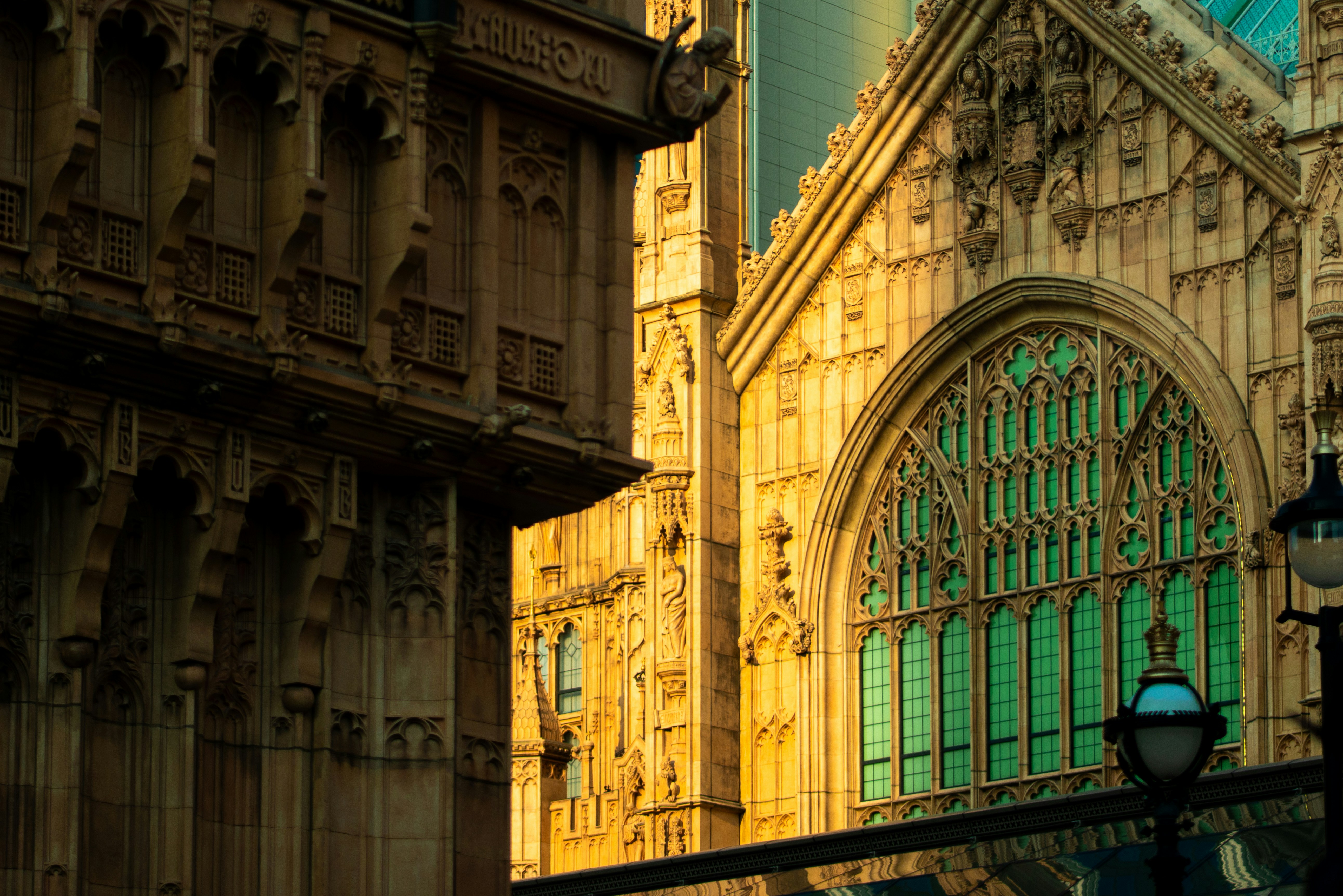 Gothic architecture with ornate stone carvings and green windows in London