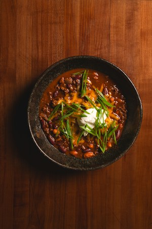 Bowl of homemade chili with beans and cheese, similar to the chili sold at the Boulder City Country Store