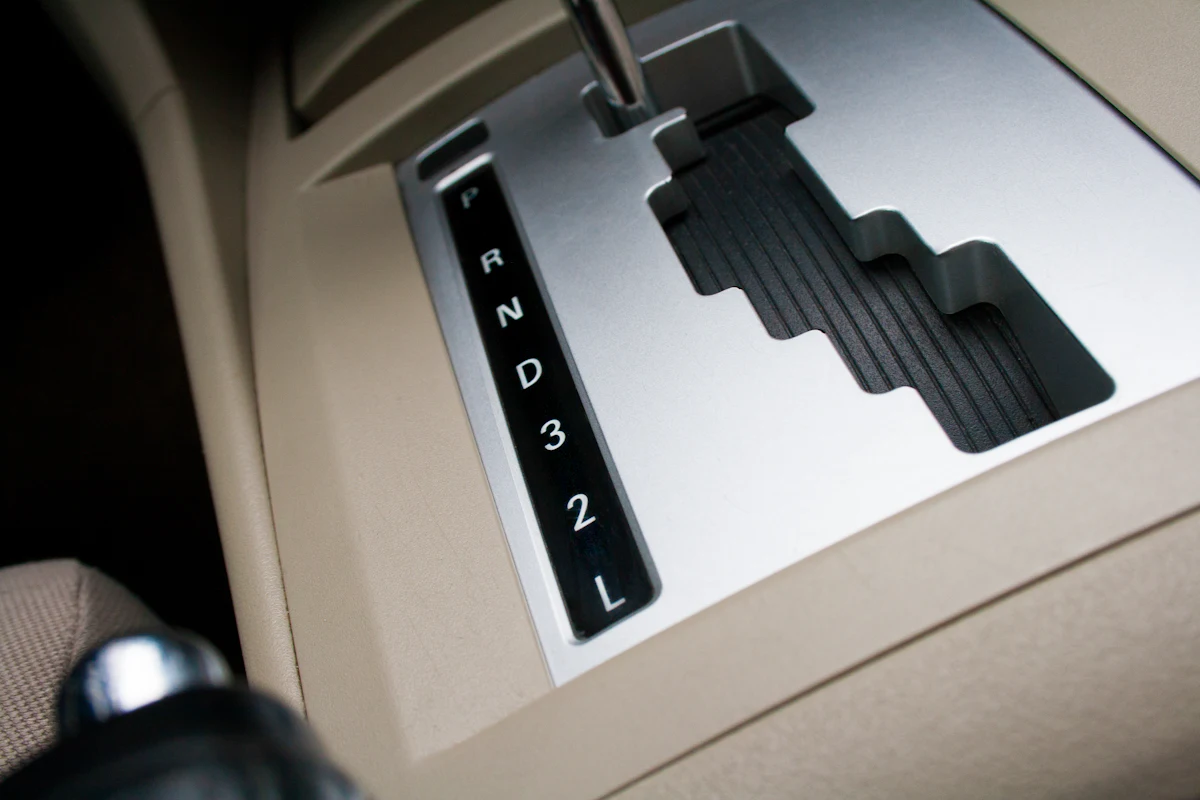 An automatic gear selector marked P R N D 3 2 L