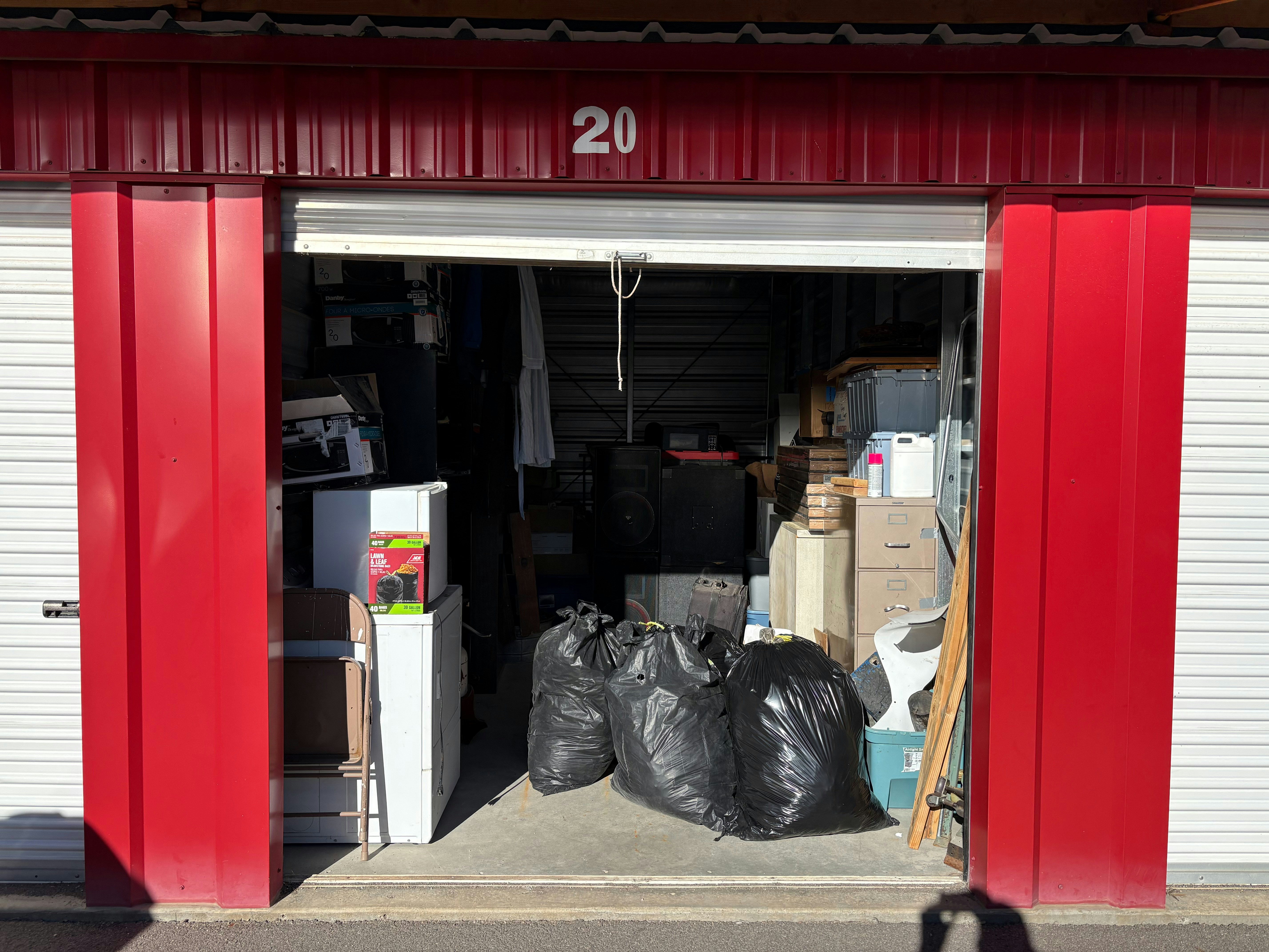 Open storage unit filled with belongings