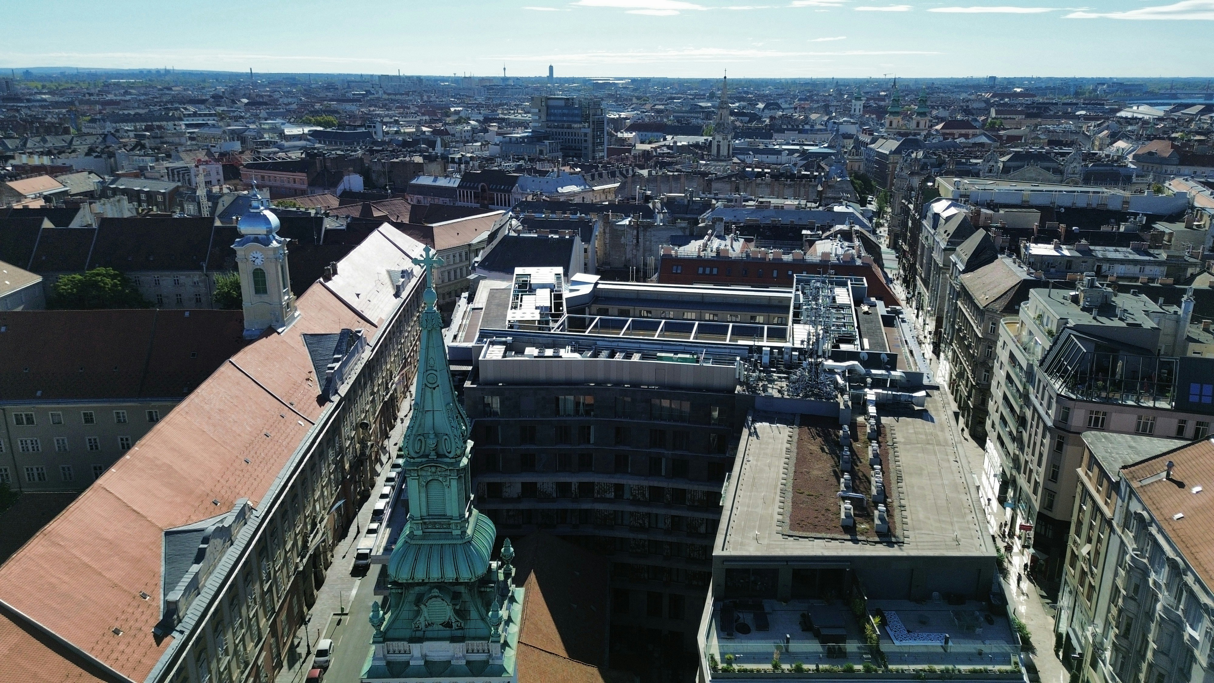 An aerial view of the city of Budapest with historic buildings and church spires