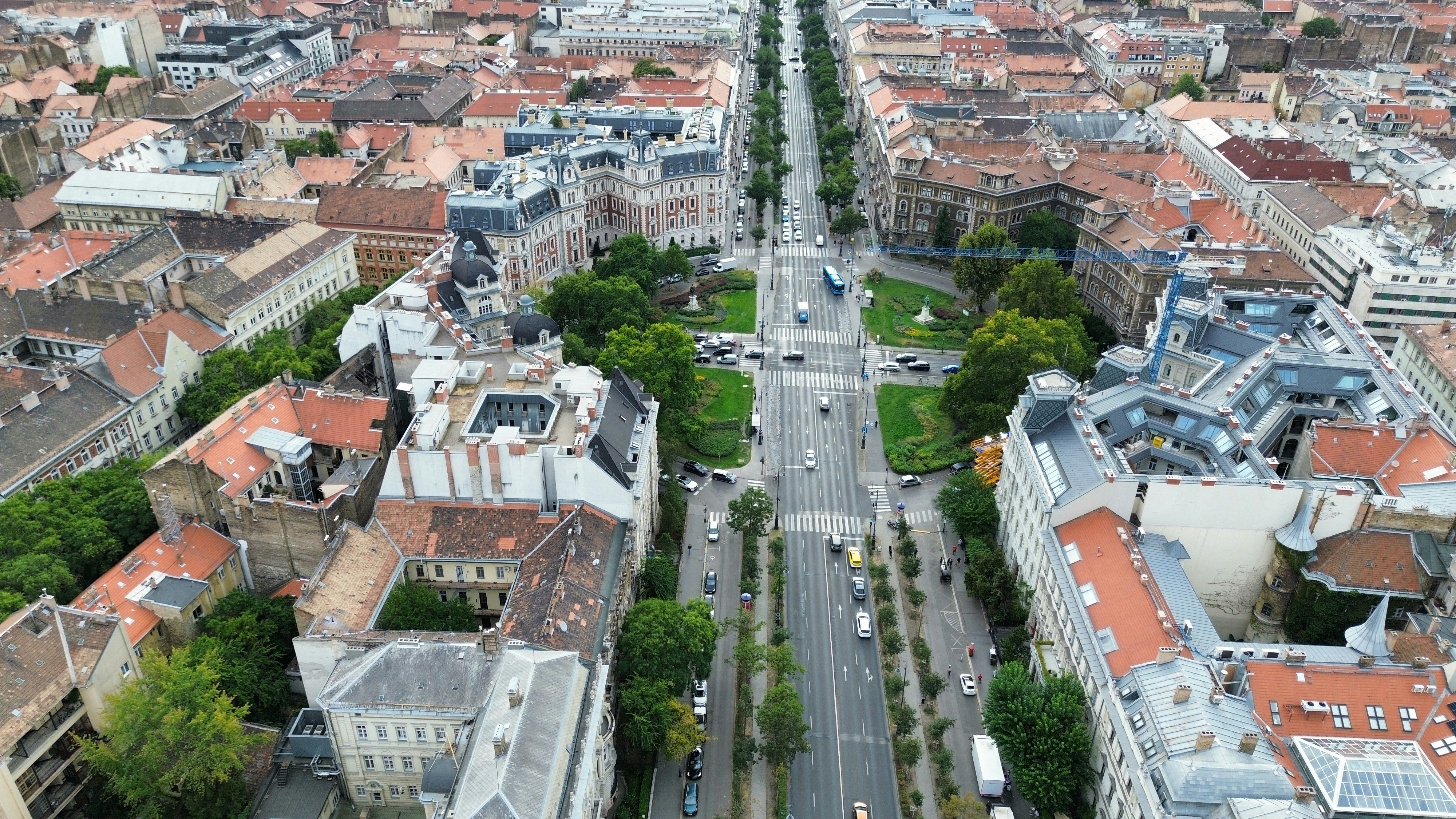 An aerial view of Andrássy Avenue with historic buildings and trees in Budapest