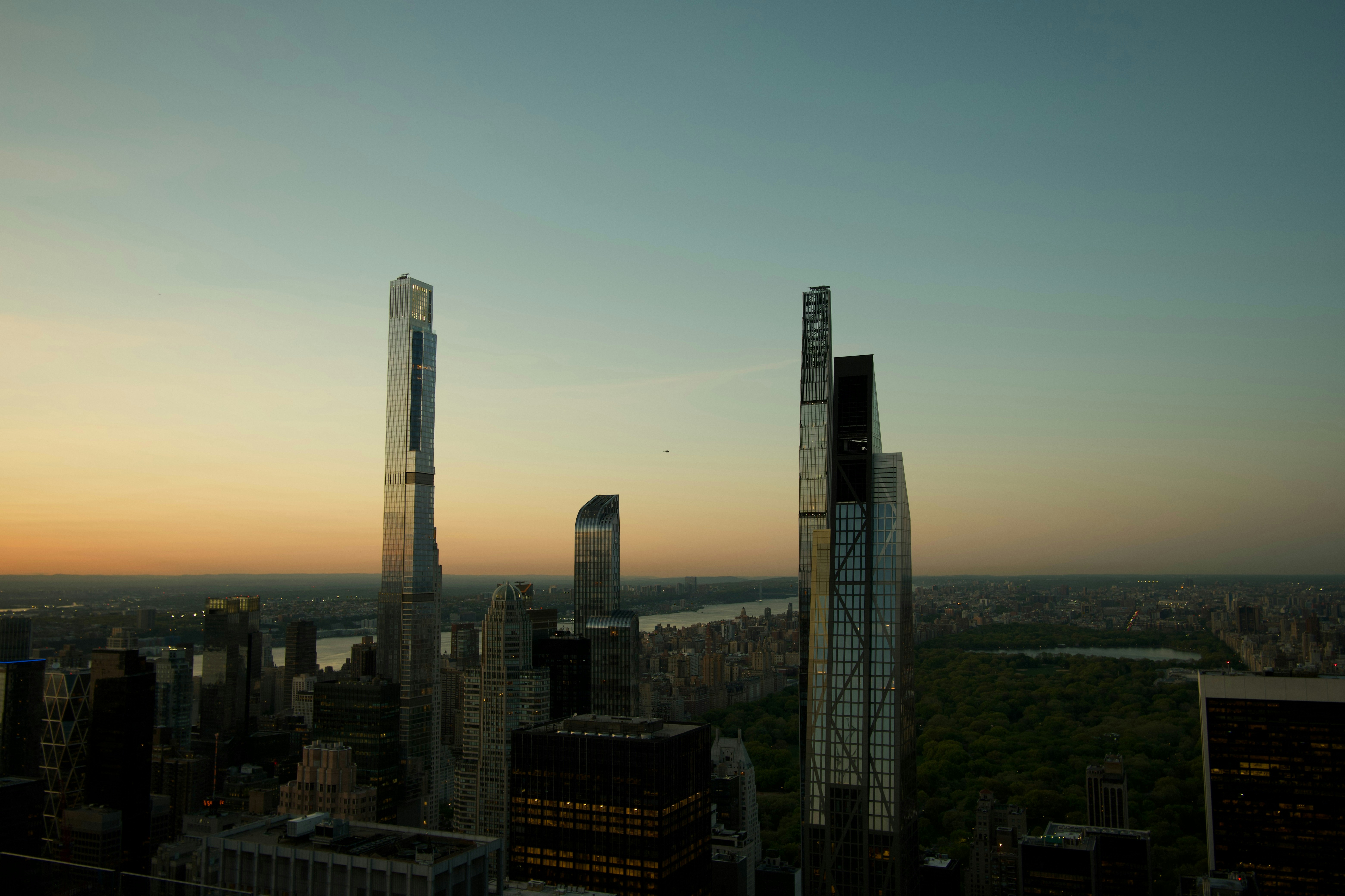 Skyscrapers rising above Central Park in New York City during the golden hour