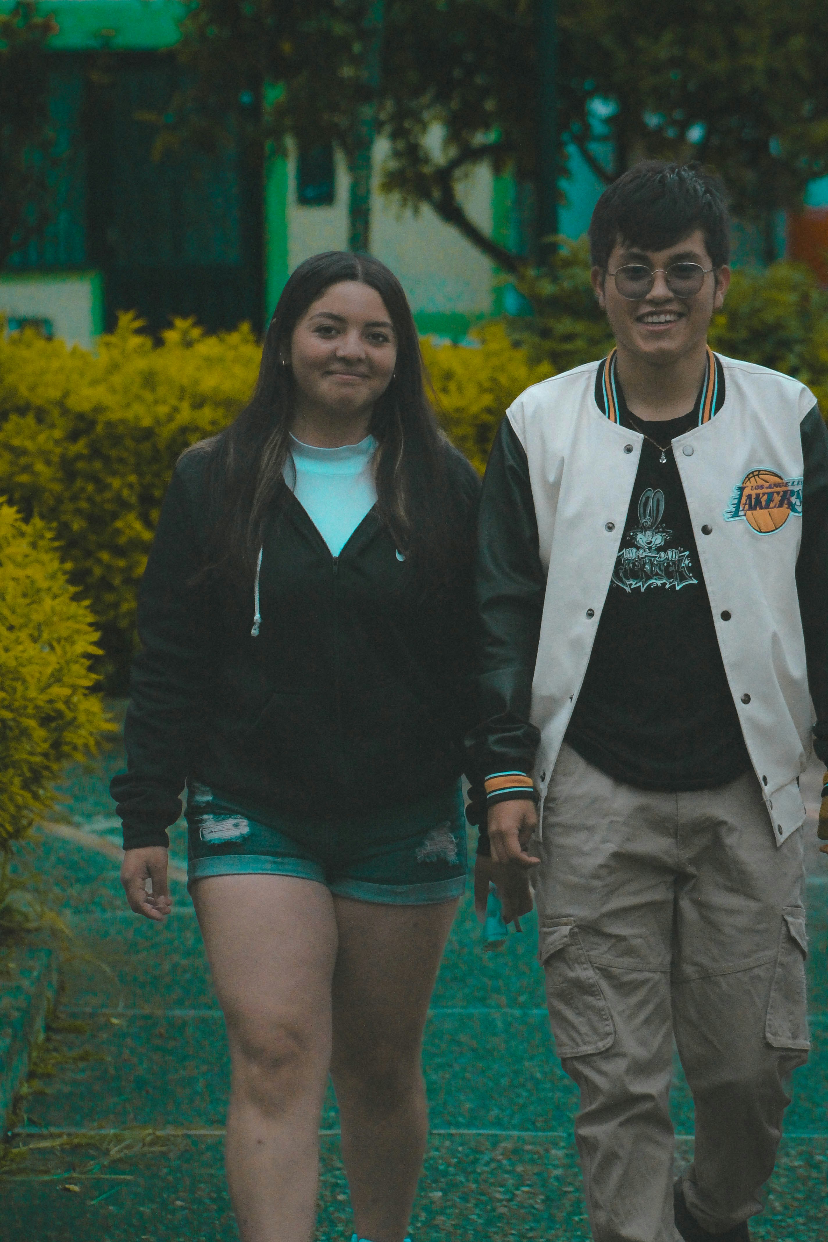 A woman and a man walking together on a path in a park
