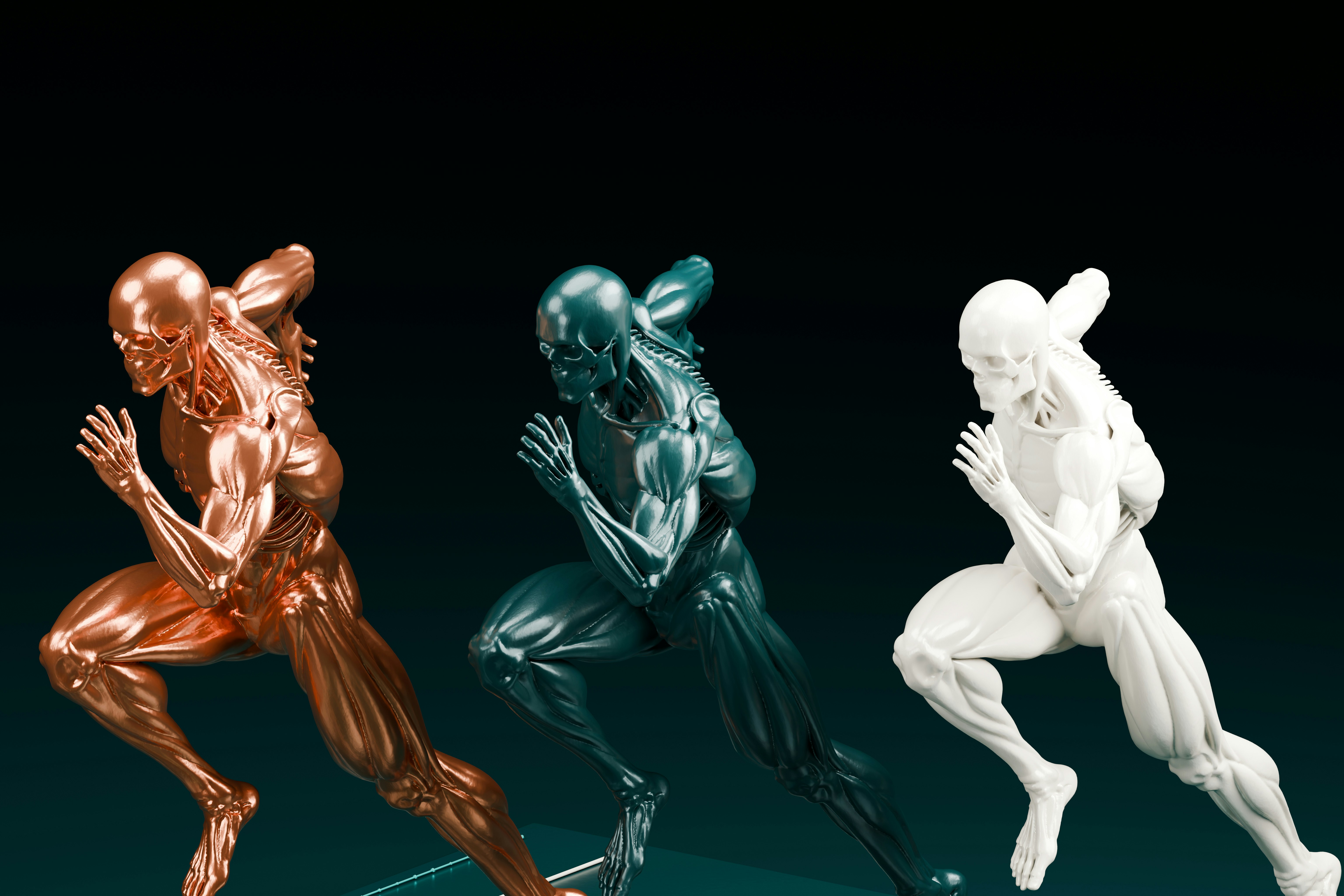 Tre figure anatomiche in pose di corsa con finiture in rame, verde scuro e bianco