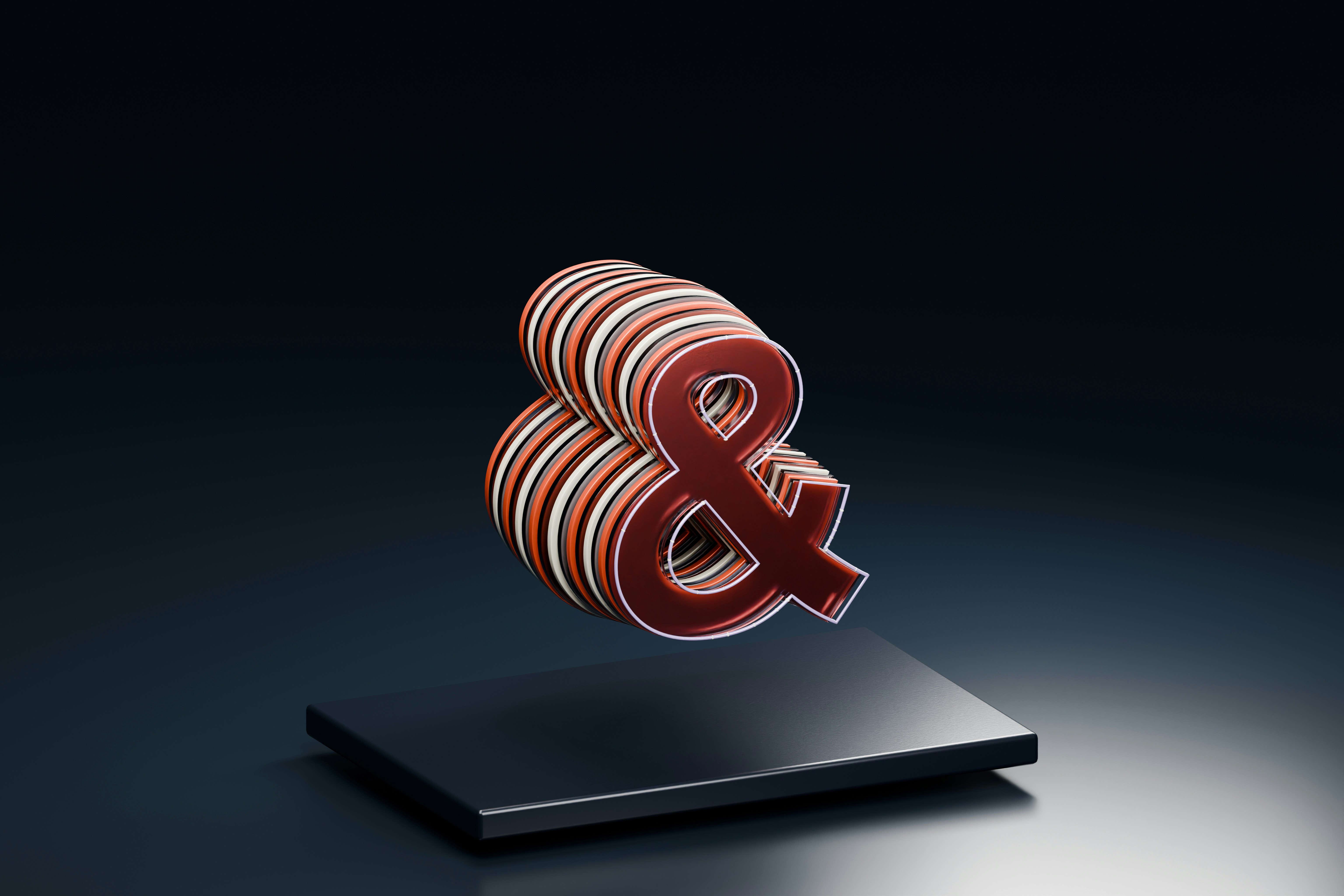 A layered red and white ampersand symbol floating above a dark rectangular base