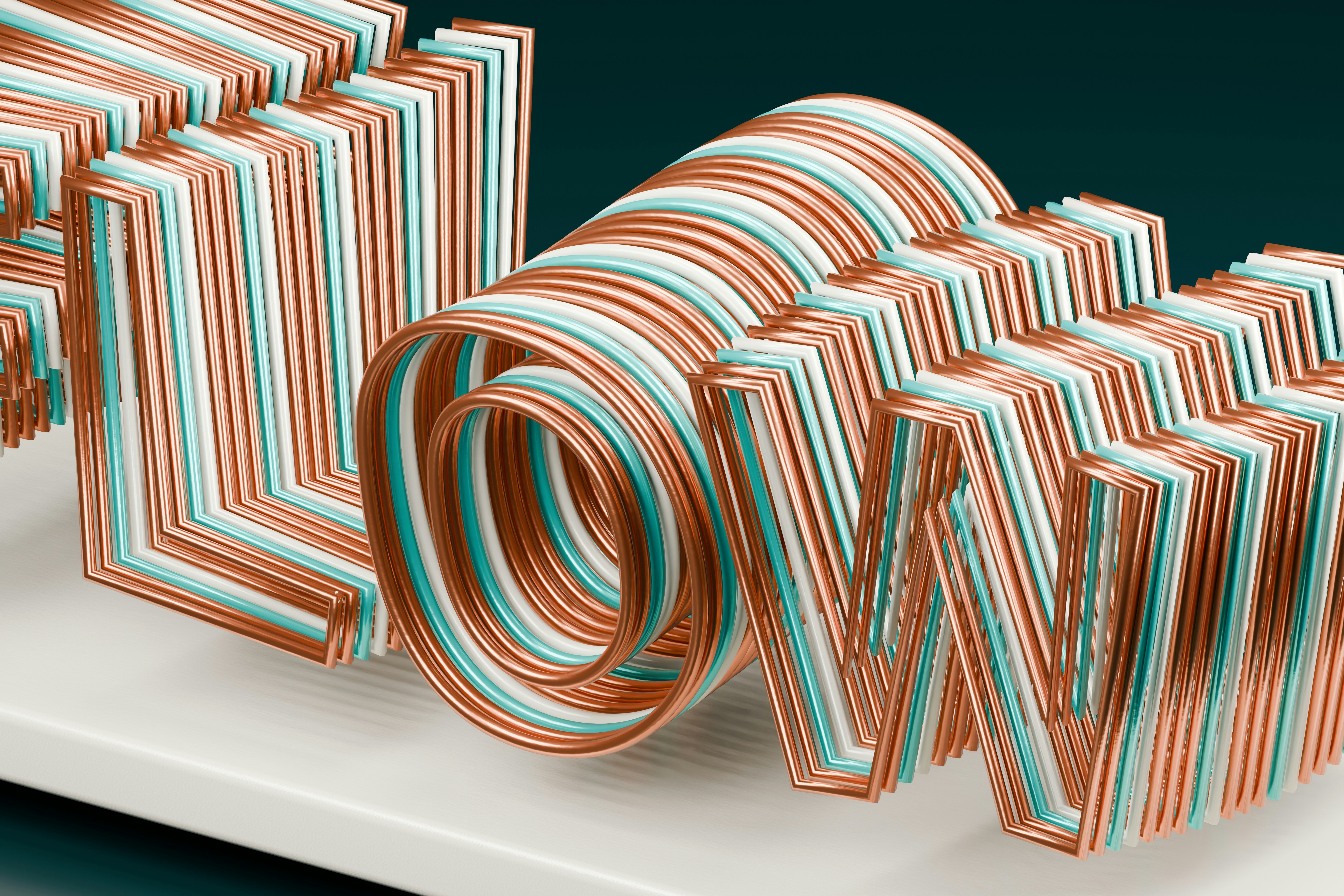 Des lettres en fil cuivre, blanc et sarcelle formant le flux de mots sur une surface