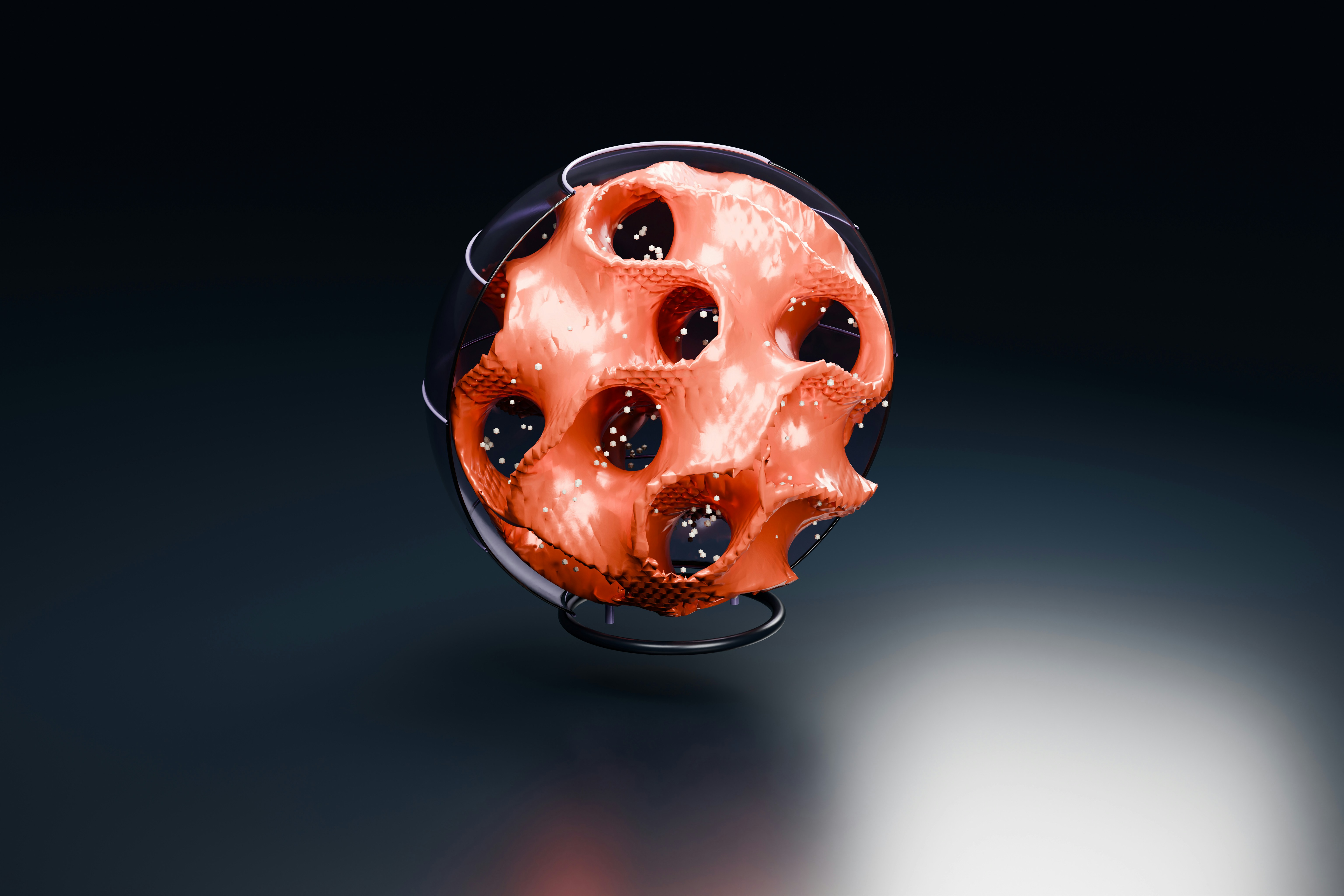 A porous gyroid sphere enclosed by a cutaway glass shell, with fine grains tracing its intricate internal surface. This sculptural 3D render explores the visual relationship between mathematics, cellular geometry and imagined advanced materials. Coral and graphite materials. Oblique three-quarter composition.