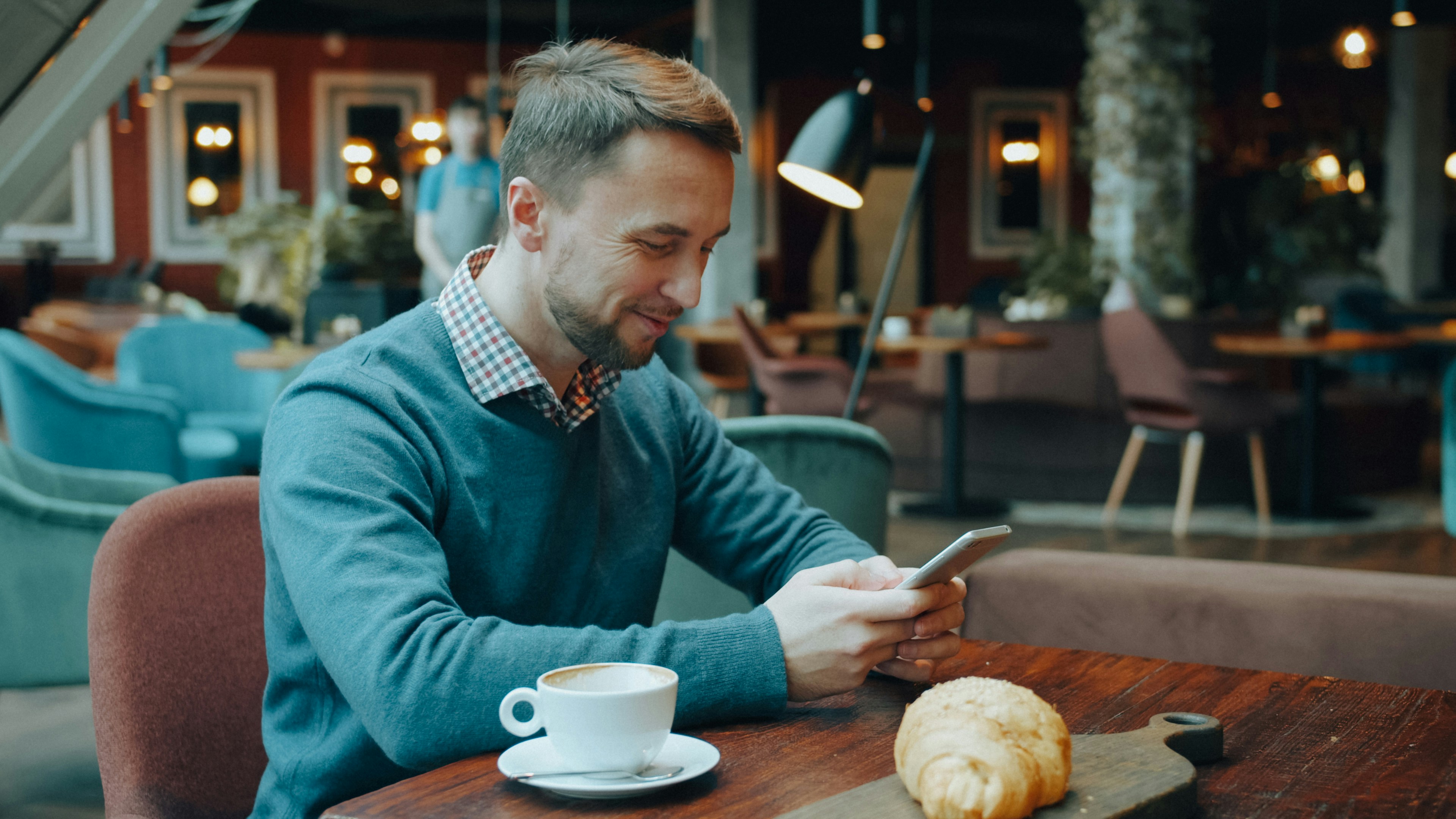 Young man using a smartphone in a café