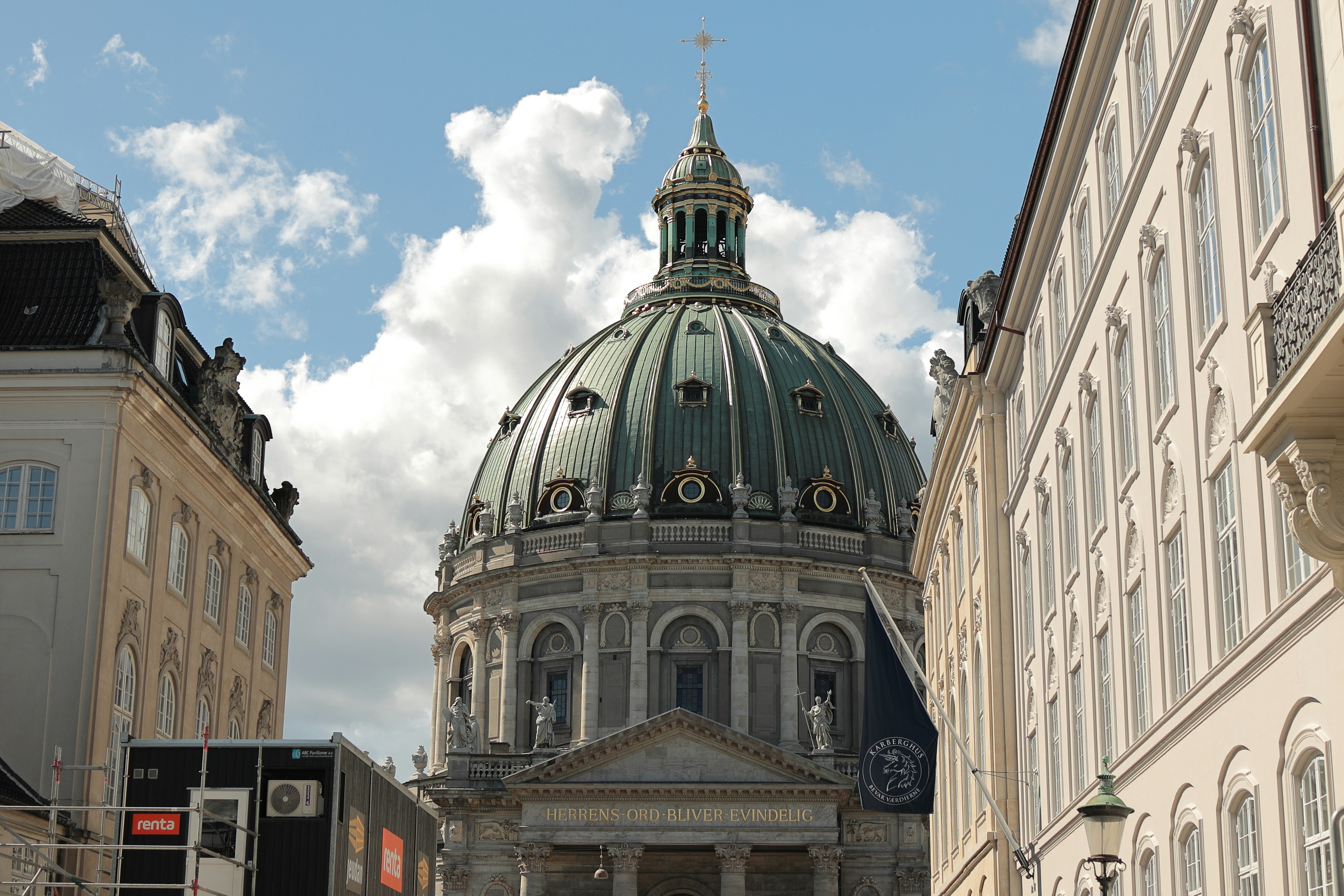 The green copper dome of Frederik's Church in Copenhagen under a blue sky