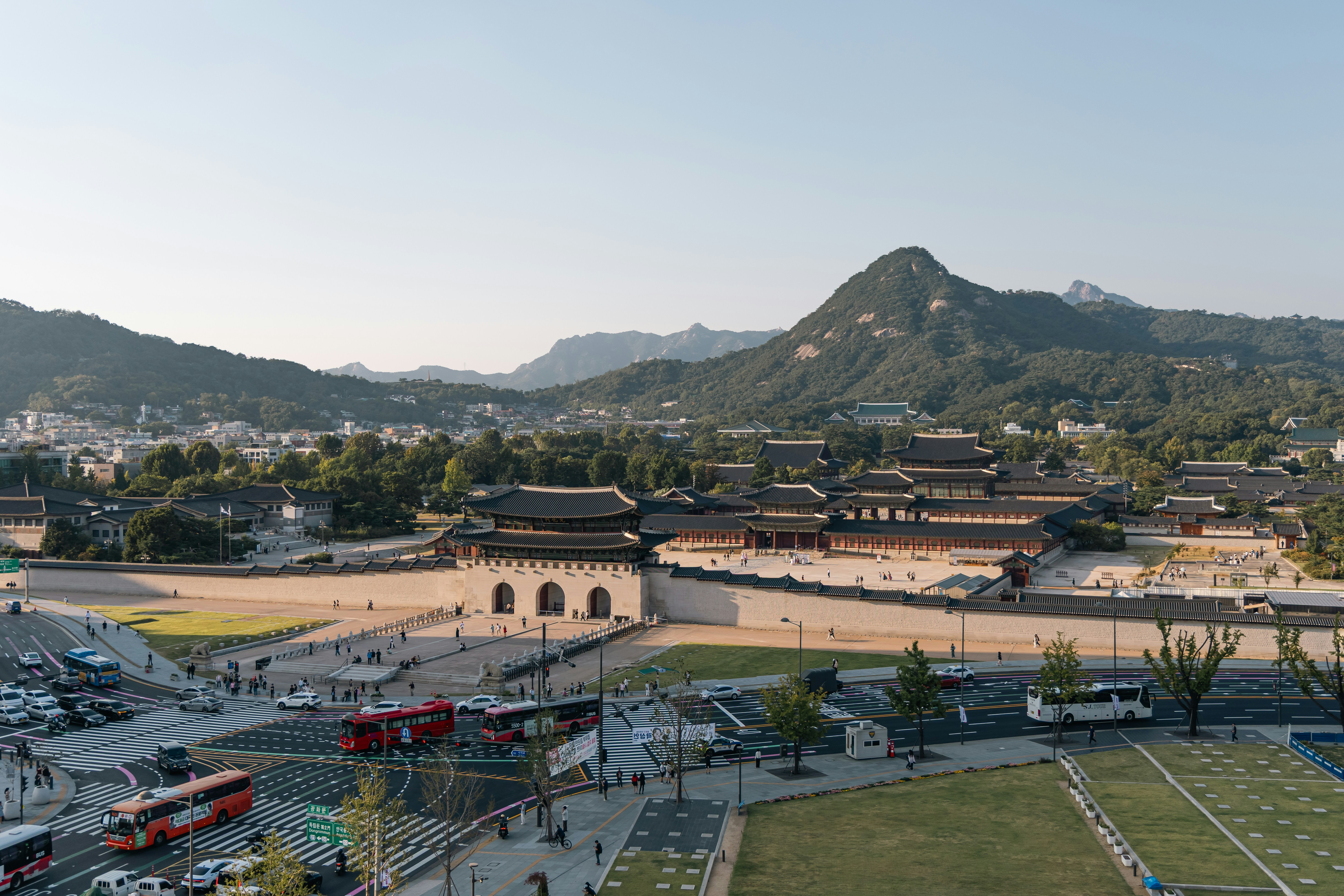 Gyeongbokgung Palace with traditional architecture behind a busy intersection in Seoul, South Korea