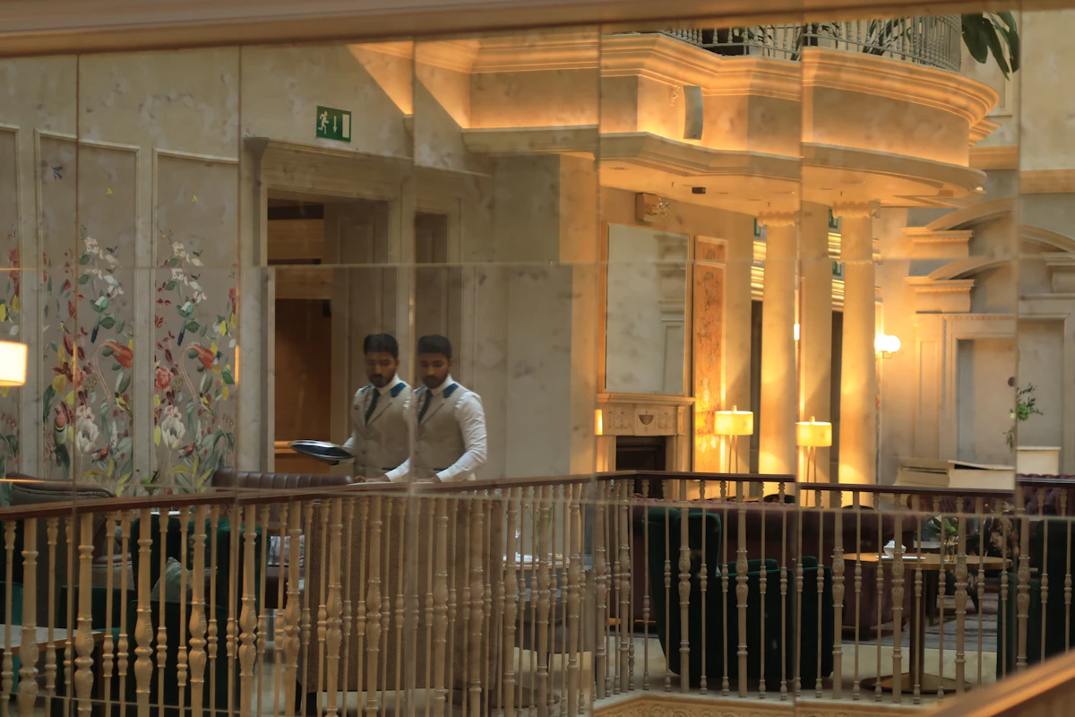Hotel team members serving in an elegant atrium lounge